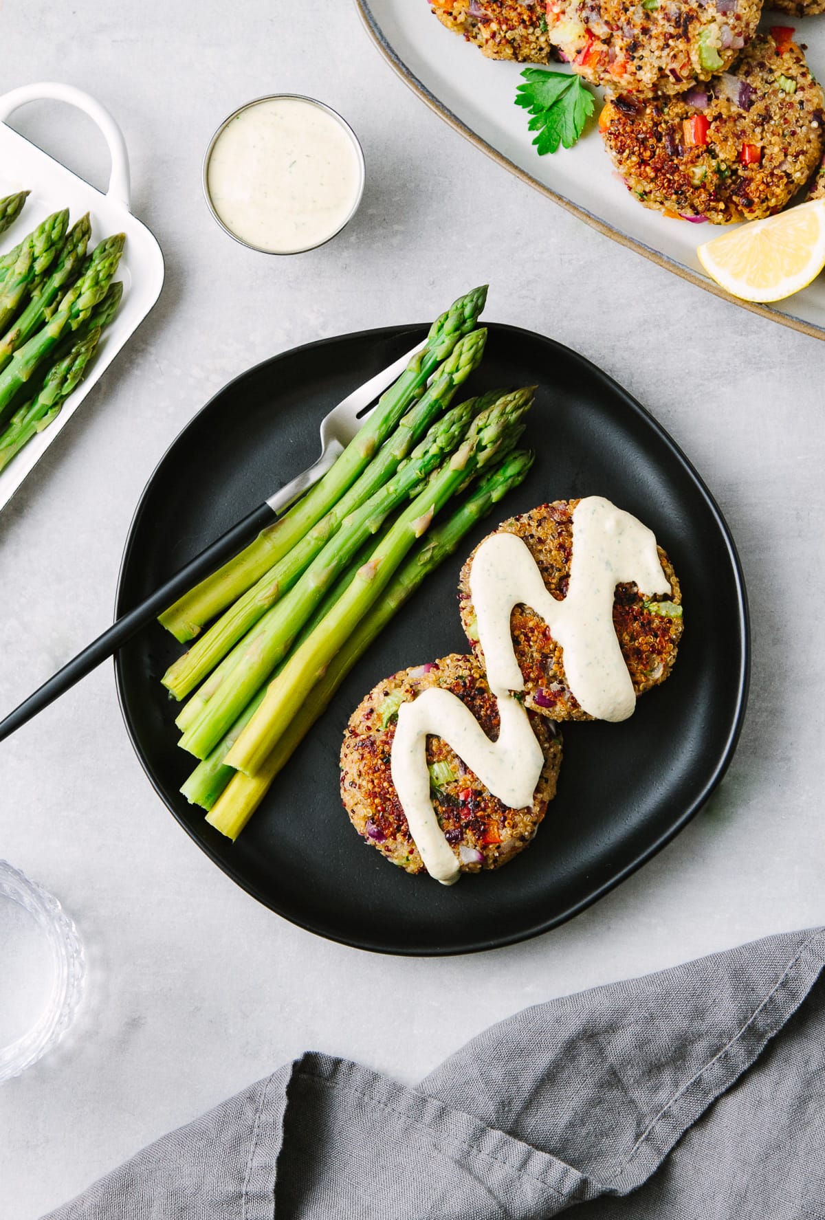 top down view of a small plate plate with crispy cajun quinoa cakes topped with creamy remoulade.