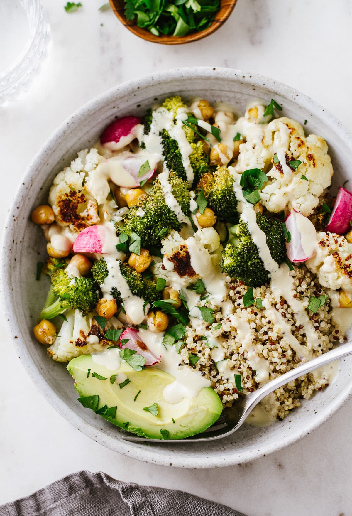 top down view of roasted vegan buddha bowl with lemon tahini dressing.