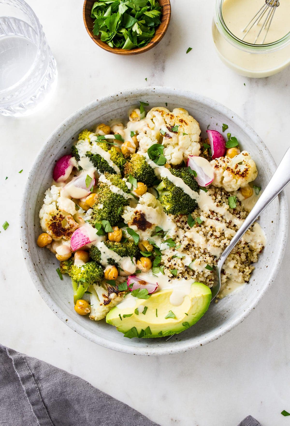 top down view of roasted vegan buddha bowl with lemon tahini dressing.