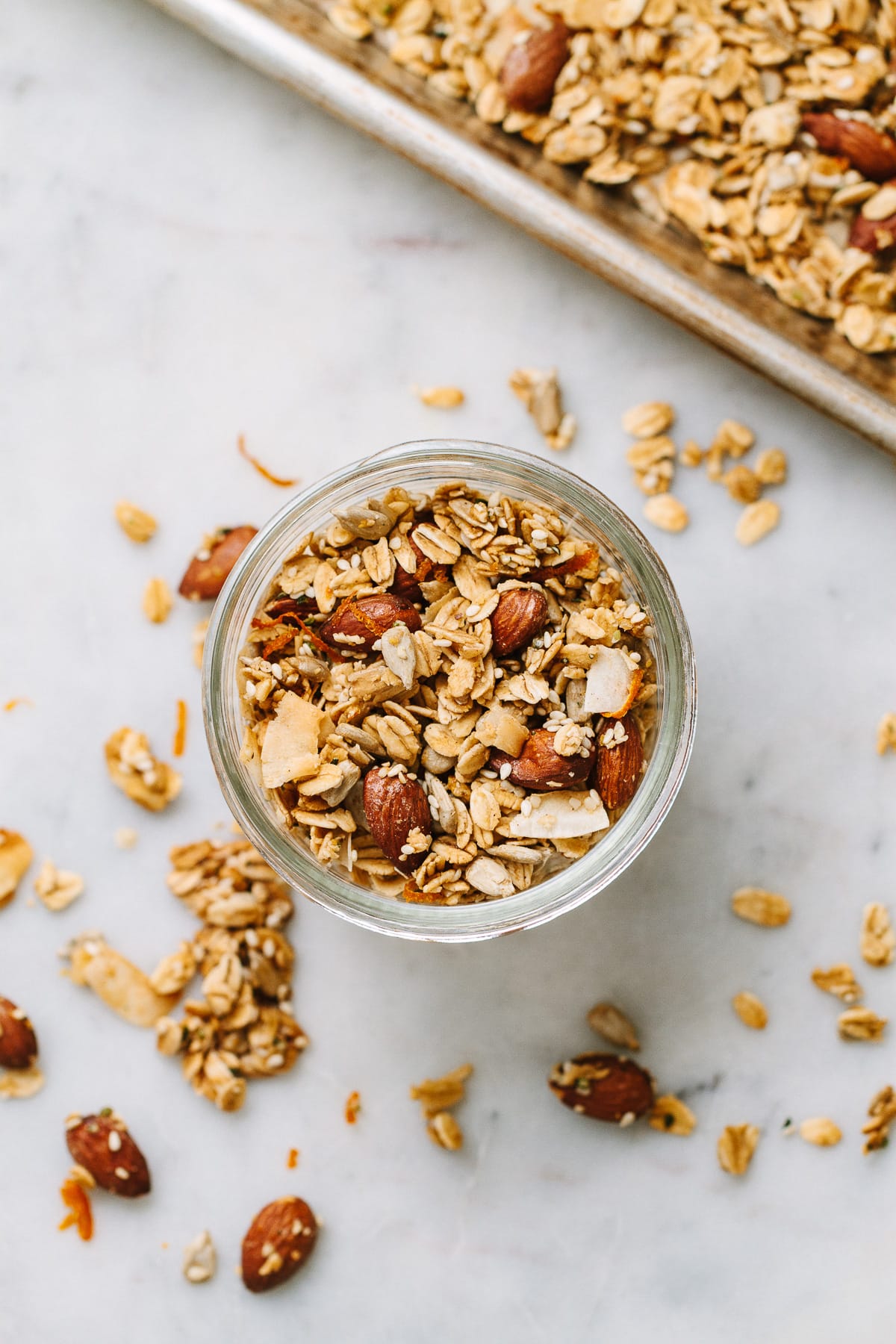 top down view of a small mason jar filled with oil free orange ginger granola.