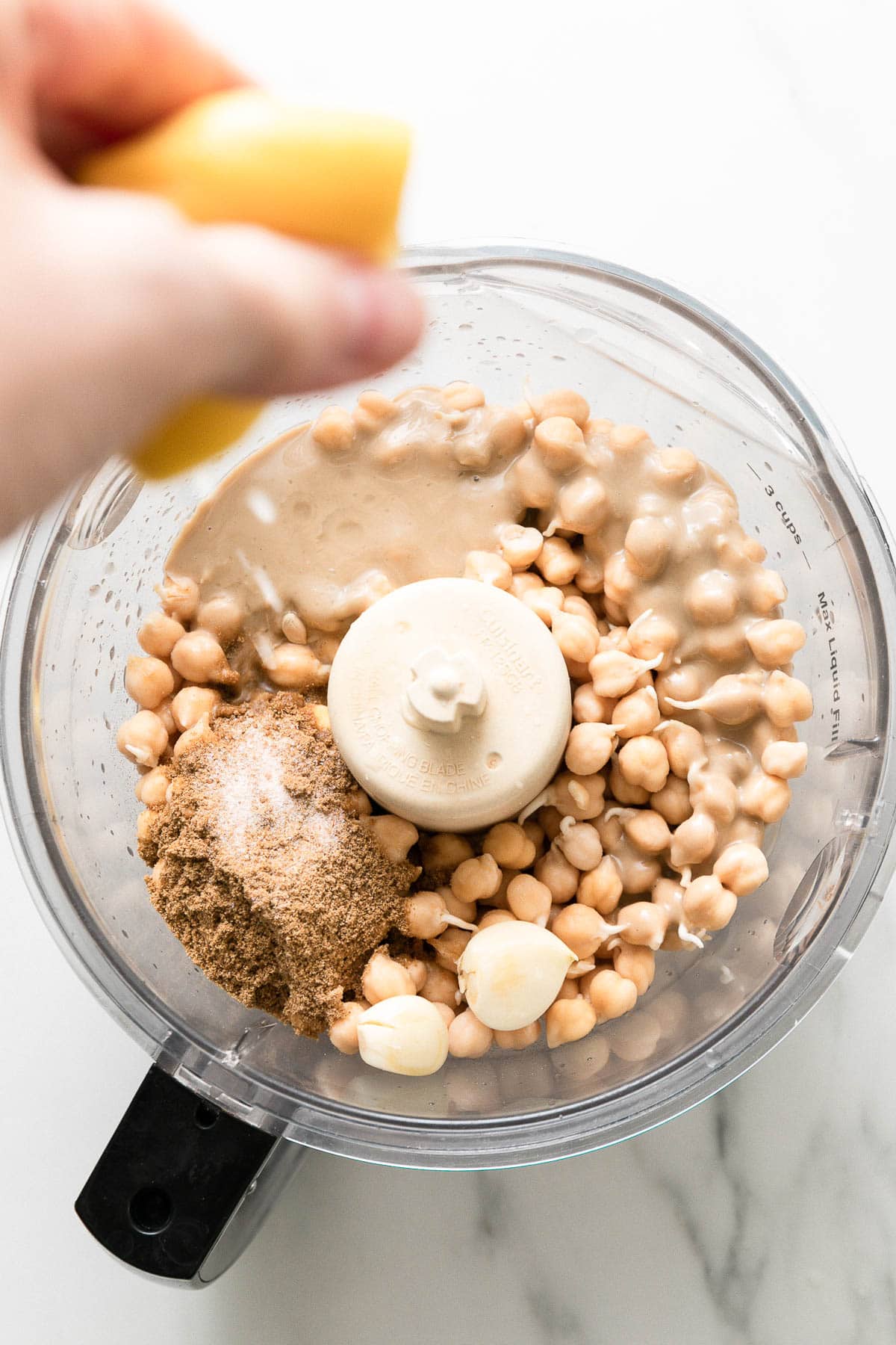 top down view showing the process of making raw sprouted chickpea hummus.