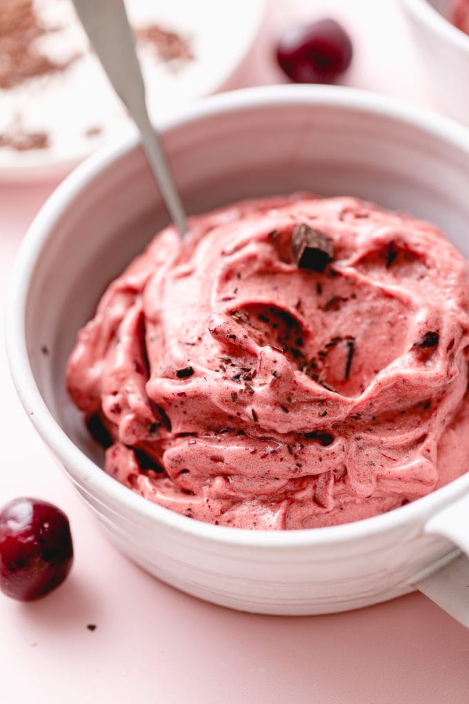 side angle view of healthy non-dairy chocolate cherry nice cream in a bowl.