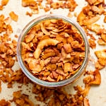 top down view of freshly made coconut bacon in a glass mason jar.