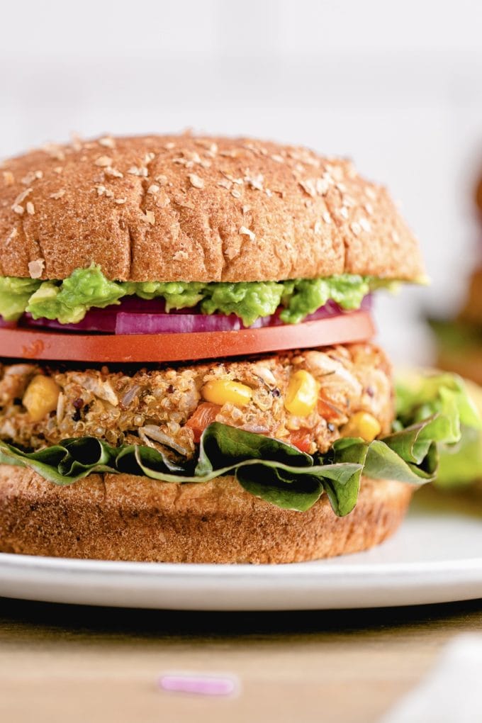 head on view of quinoa white bean veggie burger with all the fixings.
