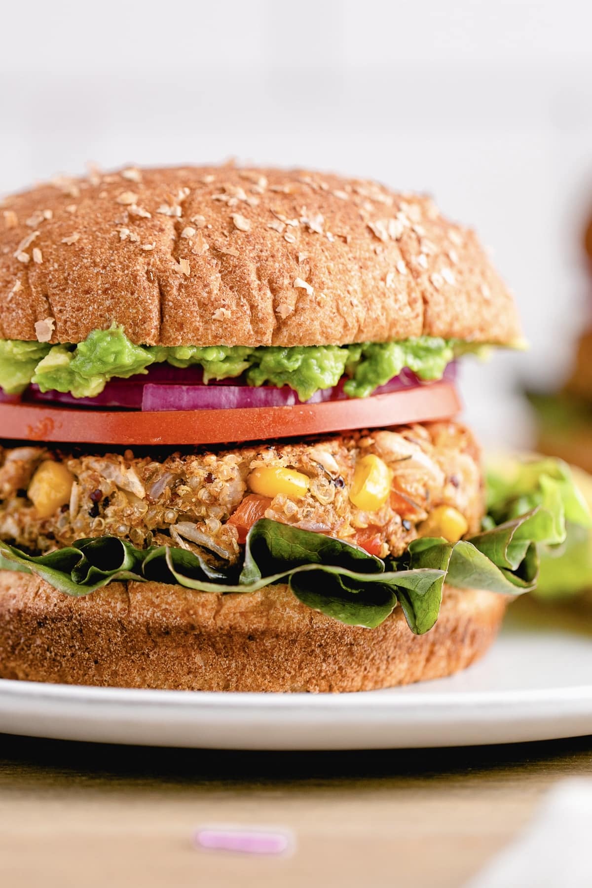 head on view of quinoa white bean veggie burger with all the fixings.