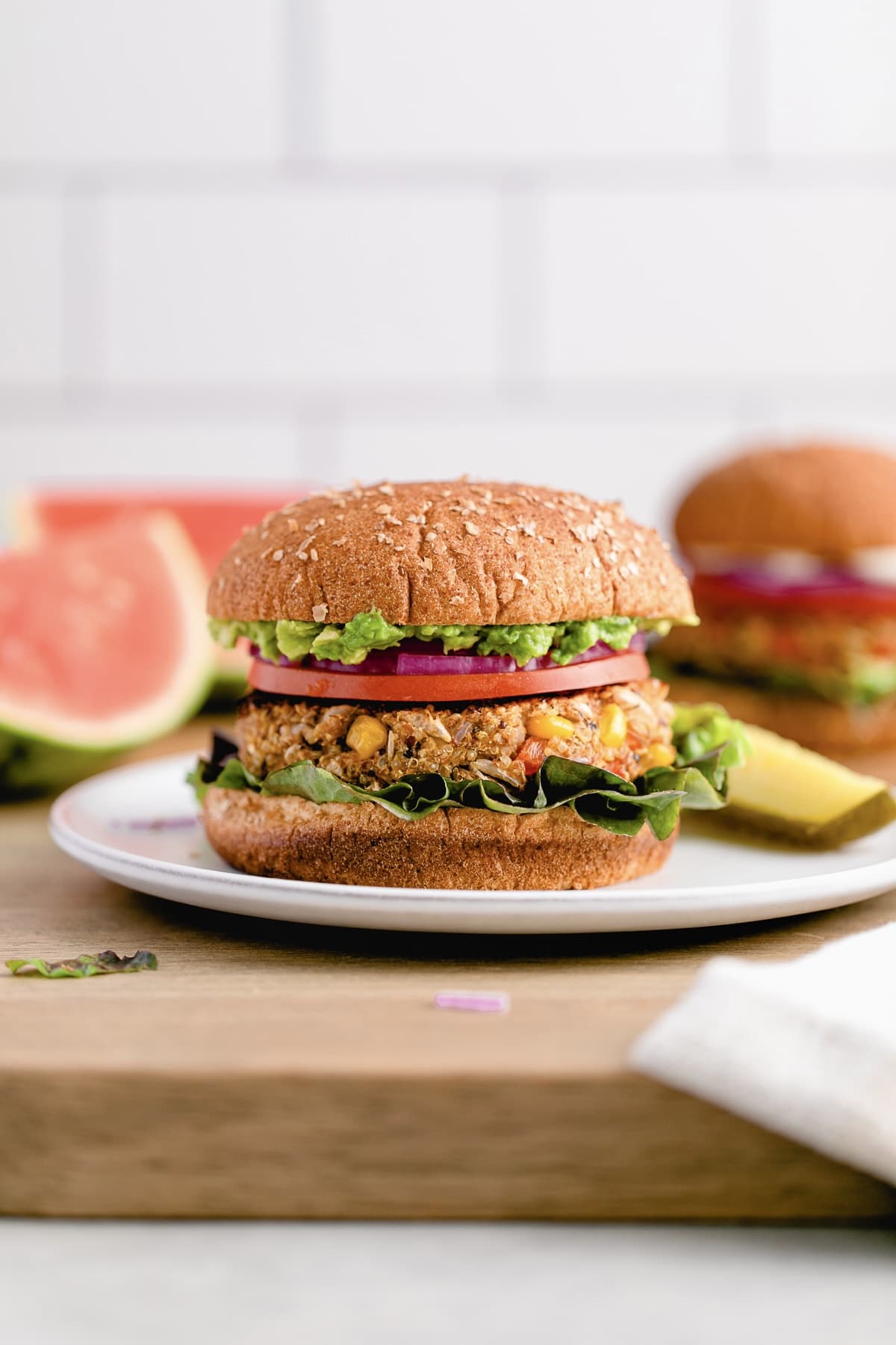 head on view of quinoa white bean veggie burger with all the fixings.