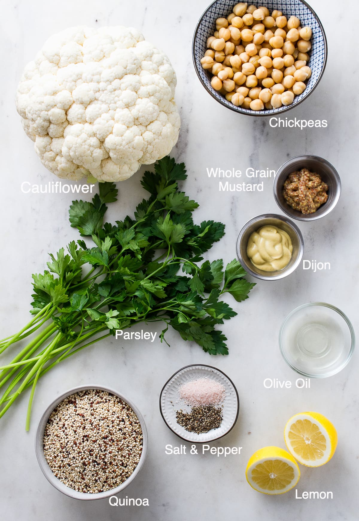 top down view of the ingredients used to make roasted cauliflower recipe with mustard dressing, chickpeas and quinoa.