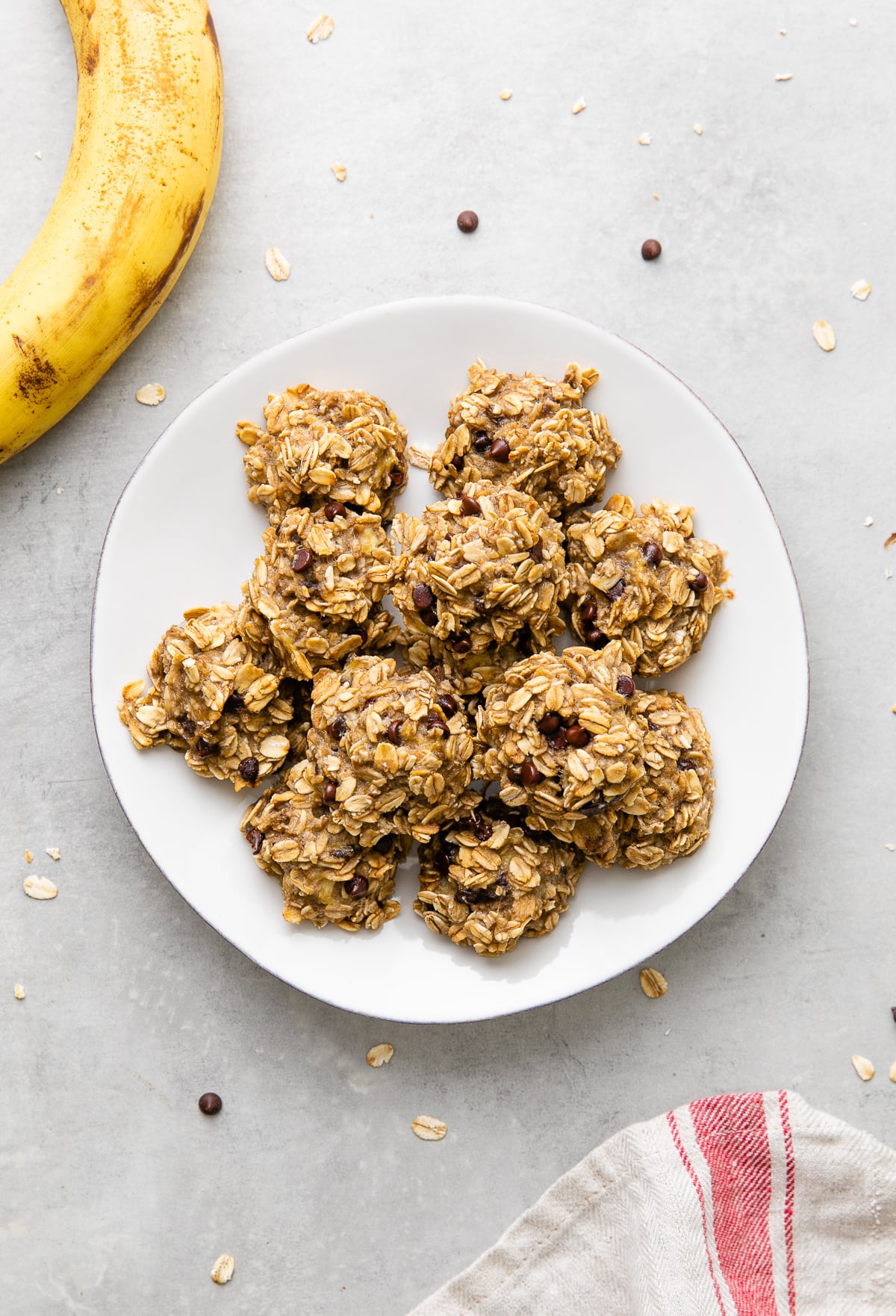 top down view of 3 ingredient banana oatmeal cookies on a plate with around.