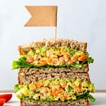 head on view of the best mashed chickpea salad sandwich cut in half and stacked.