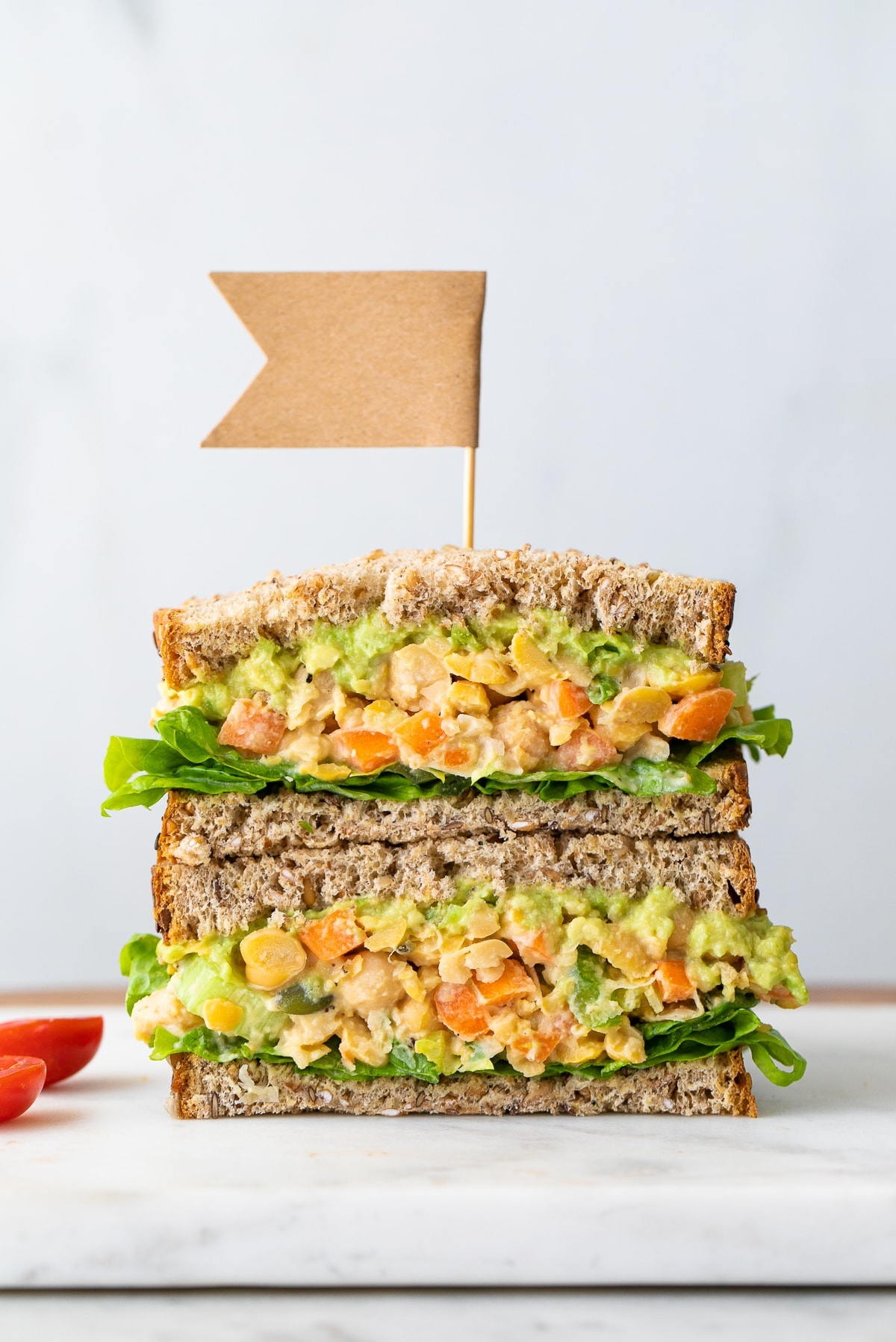 head on view of the best mashed chickpea salad sandwich cut in half and stacked.