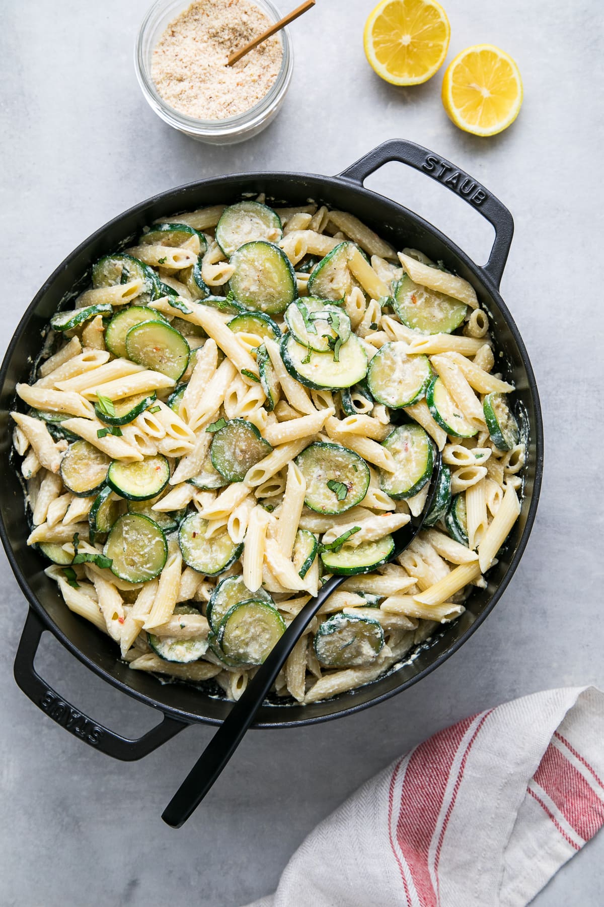 top down view of a pot with freshly made zucchini ricotta pasta with mint and basil.