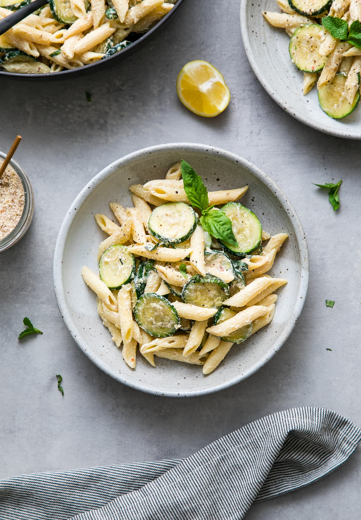 top down view of a bowl filled with vegan zucchini ricotta pasta with basil.