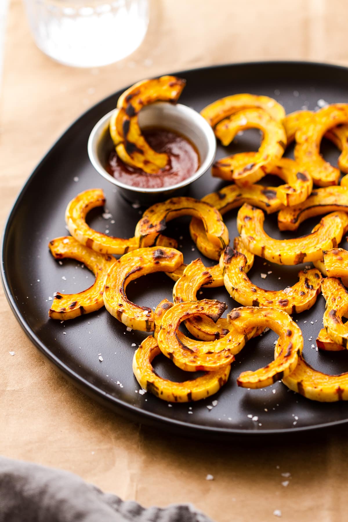 side angle view of roasted delicata squash fries with sriracha.