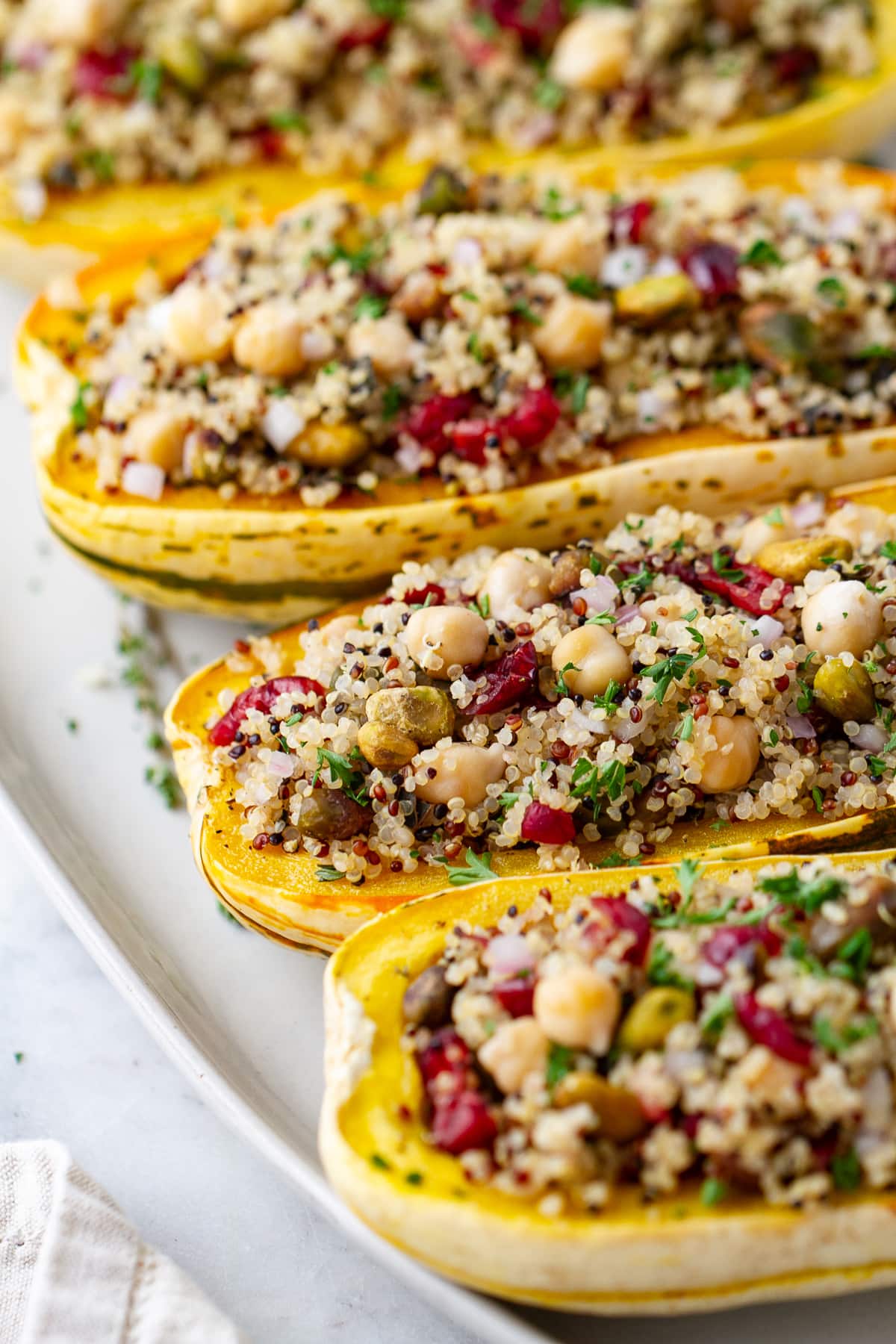 side angle view of stuffed delicata squash with quinoa.