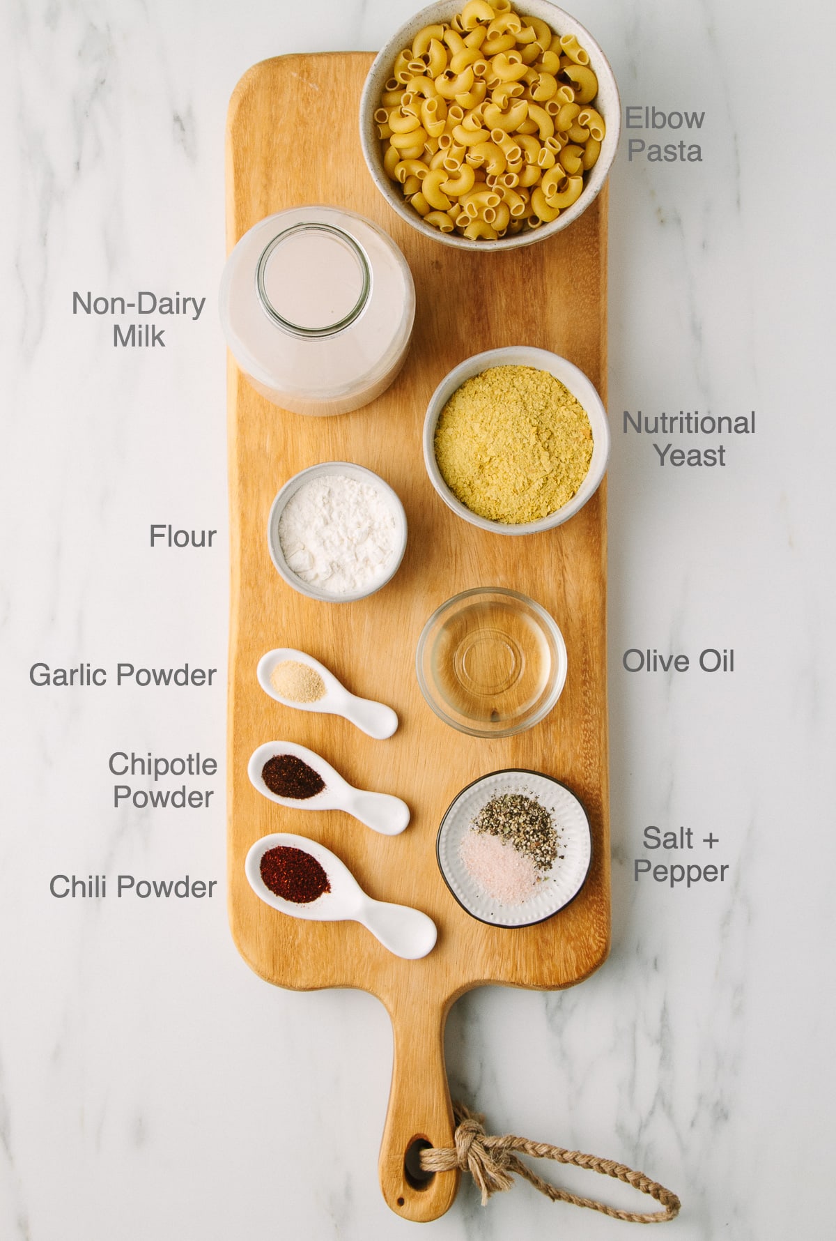top down view of ingredients used to make vegan spicy mac and cheese recipe with nutritional yeast, flour and oil.