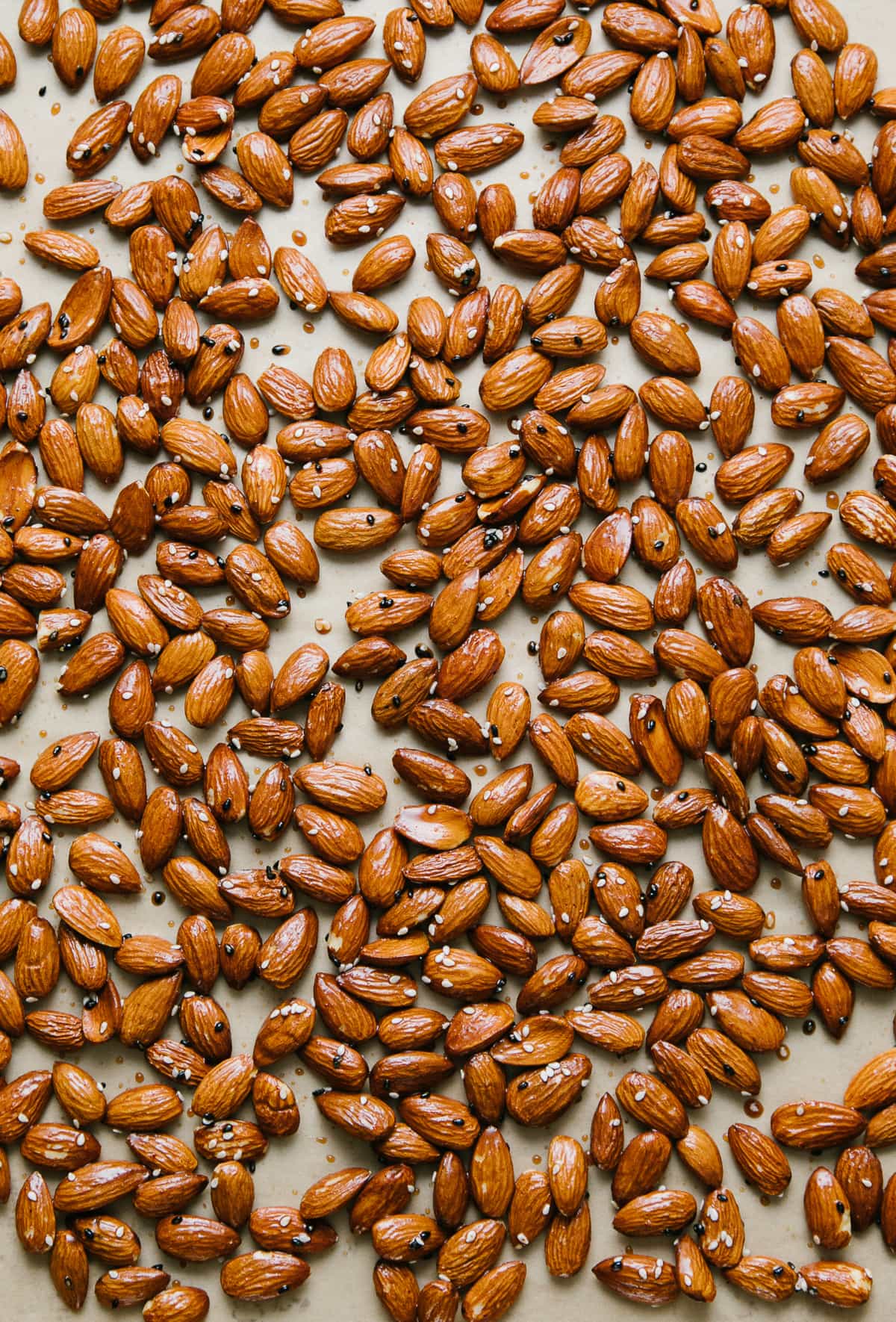 top down view of almonds seasoned, layered on a baking sheet and ready for the oven.