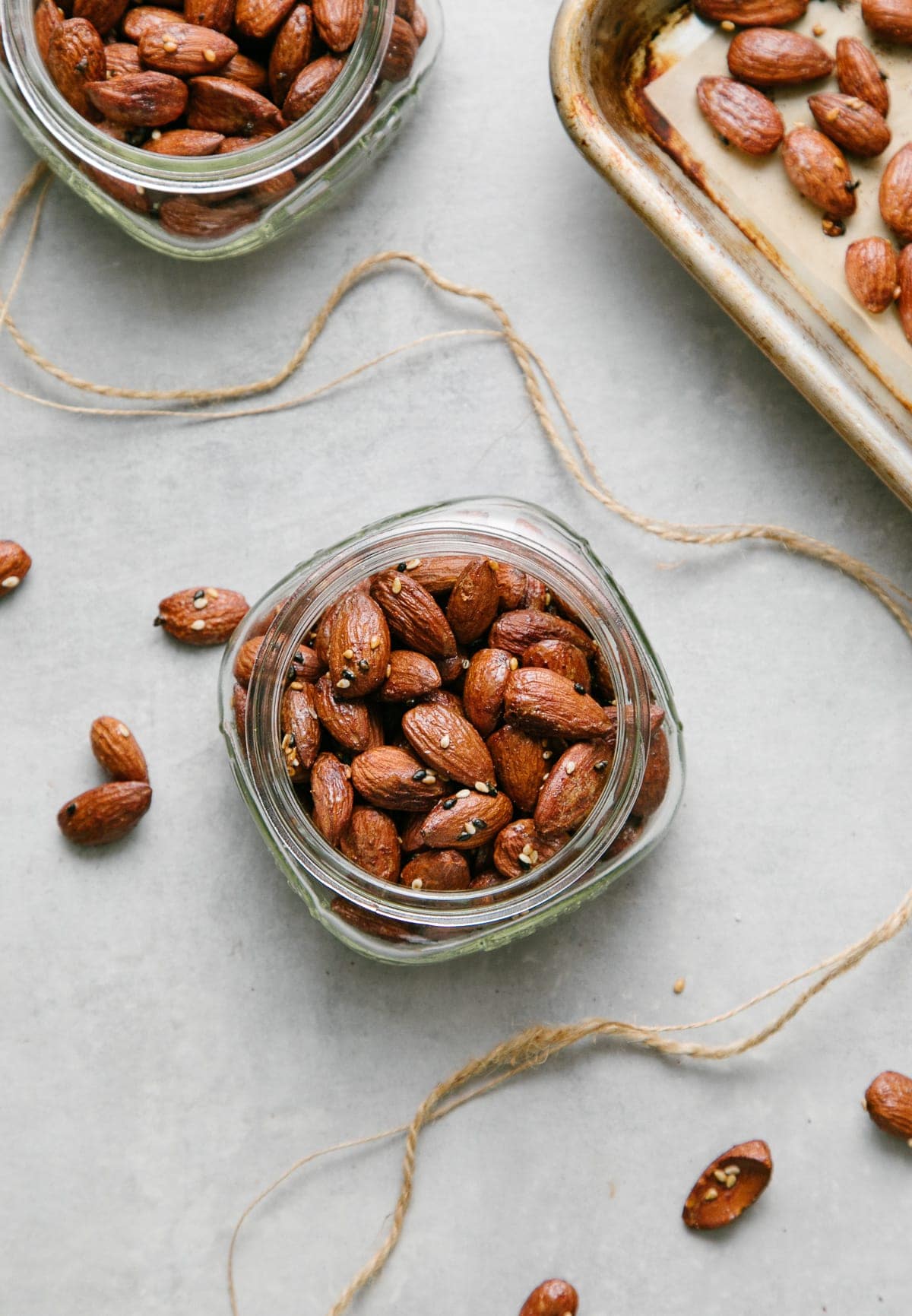 top down view of roasted almonds in small glass jars for gift giving.