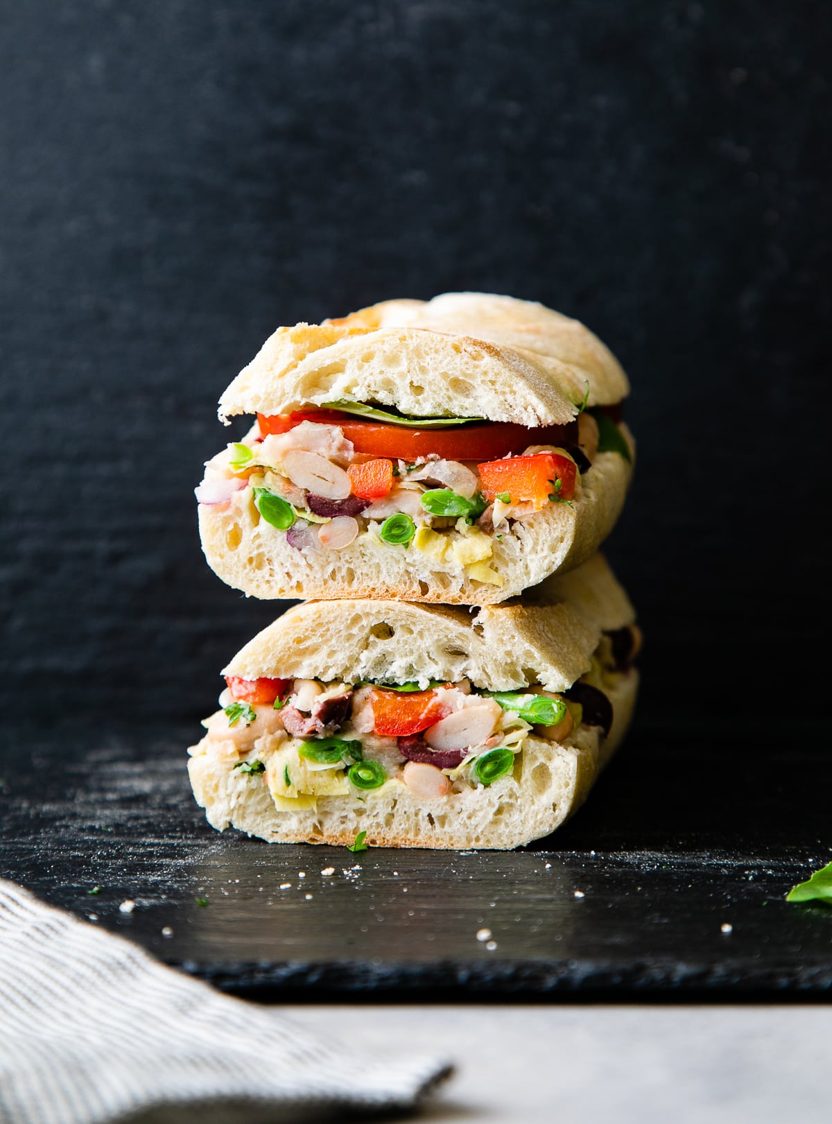 head on view of two halves of vegetarian pan bagnat stacked.