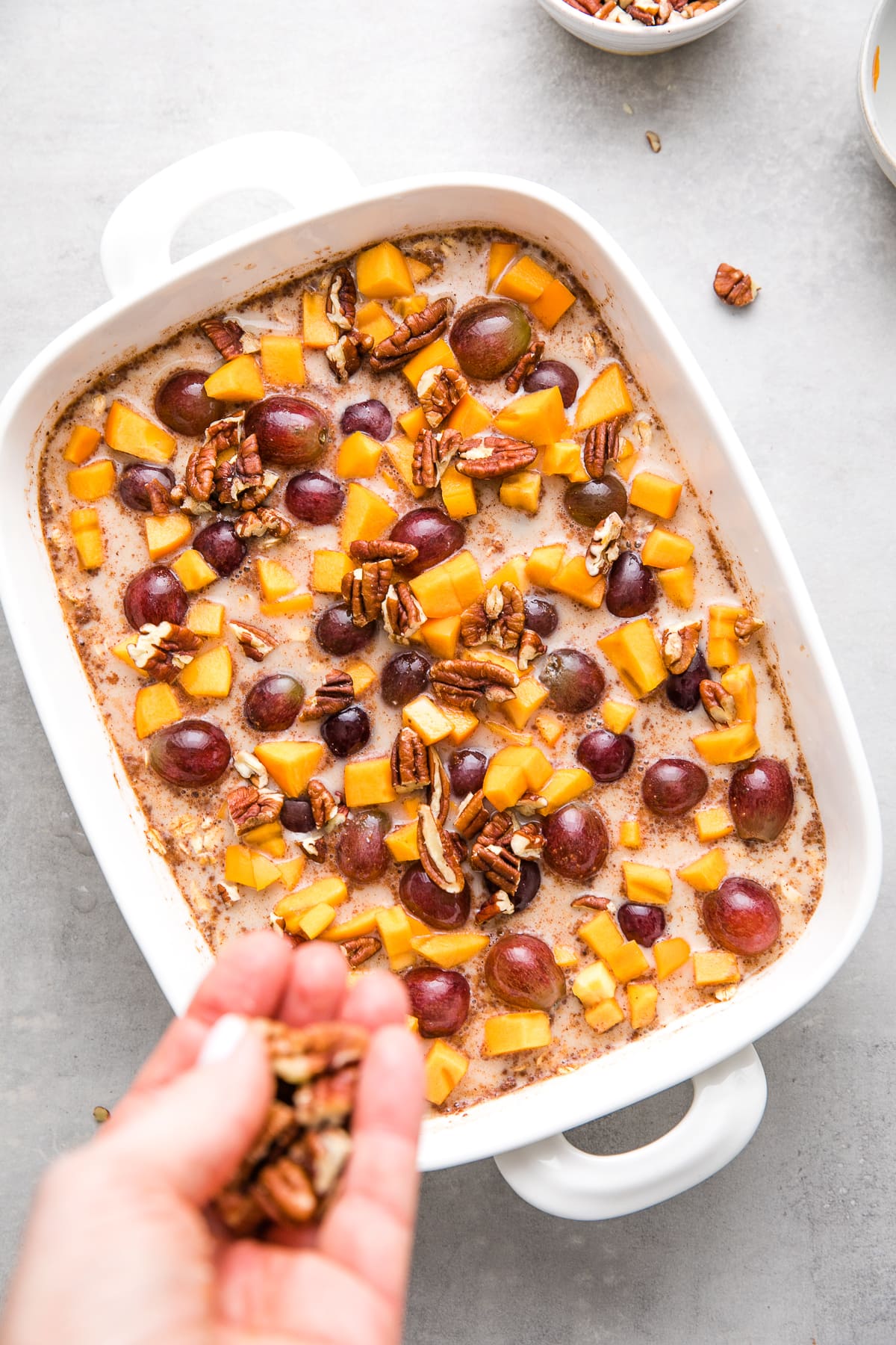 top down view of fruit and nuts added wet oatmeal mix just before baking.