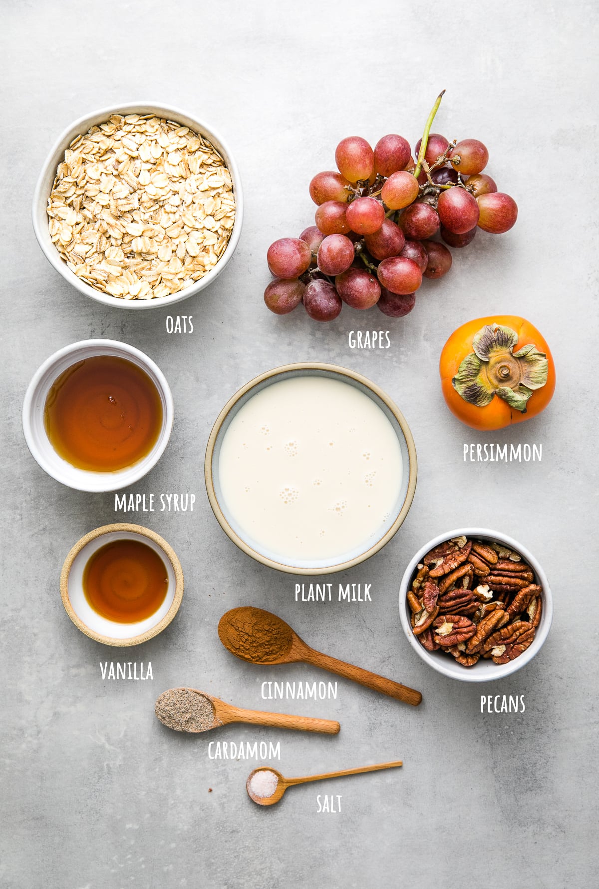 top down view of ingredients used to make healthy baked oatmeal with persimmon and grapes.