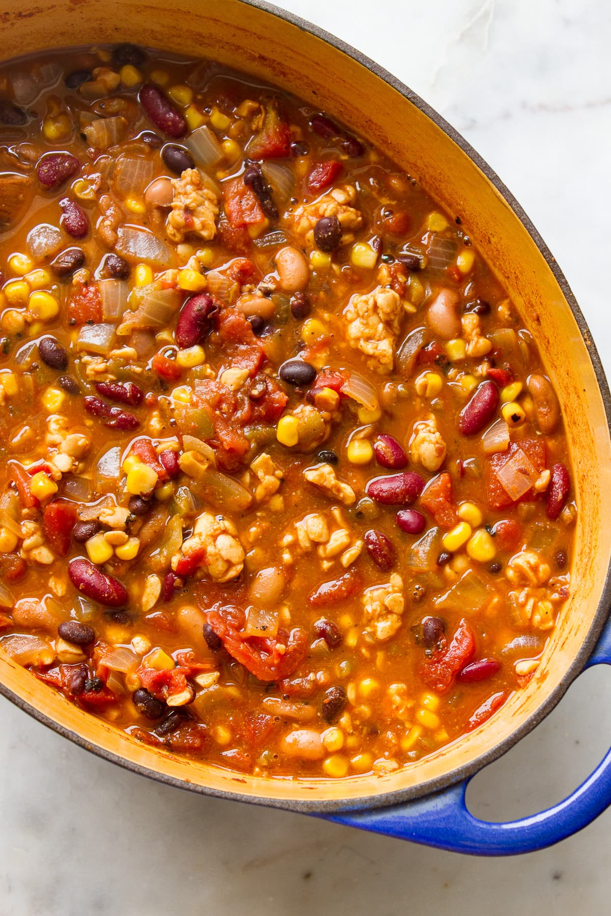 top down view of dutch oven with freshly made tempeh chili.