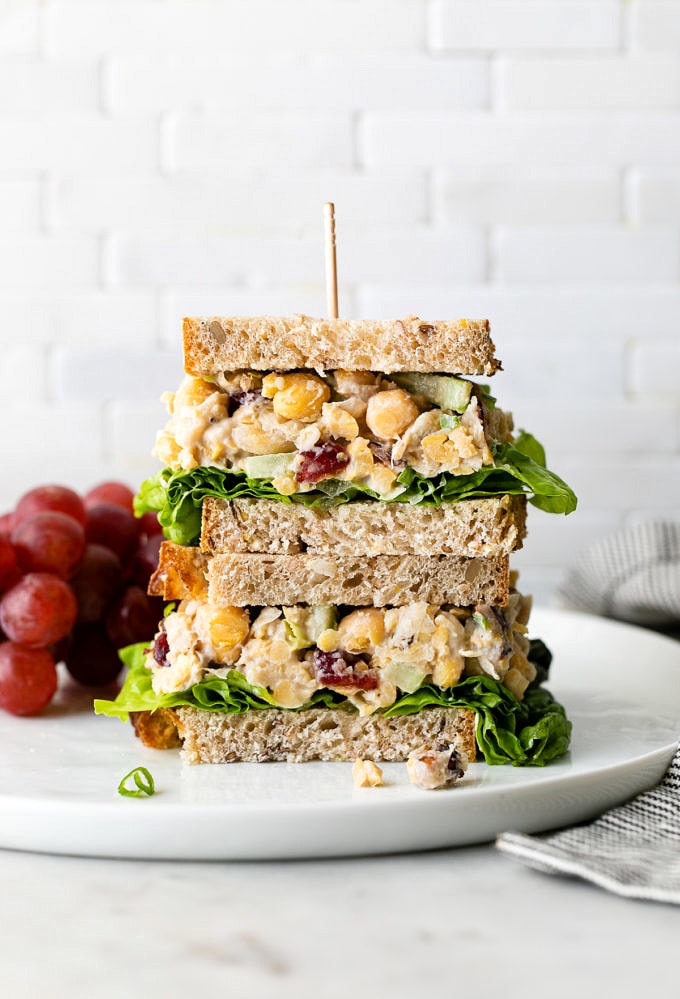 head on view of vegan chicken salad sandwich cut in half and stacked.
