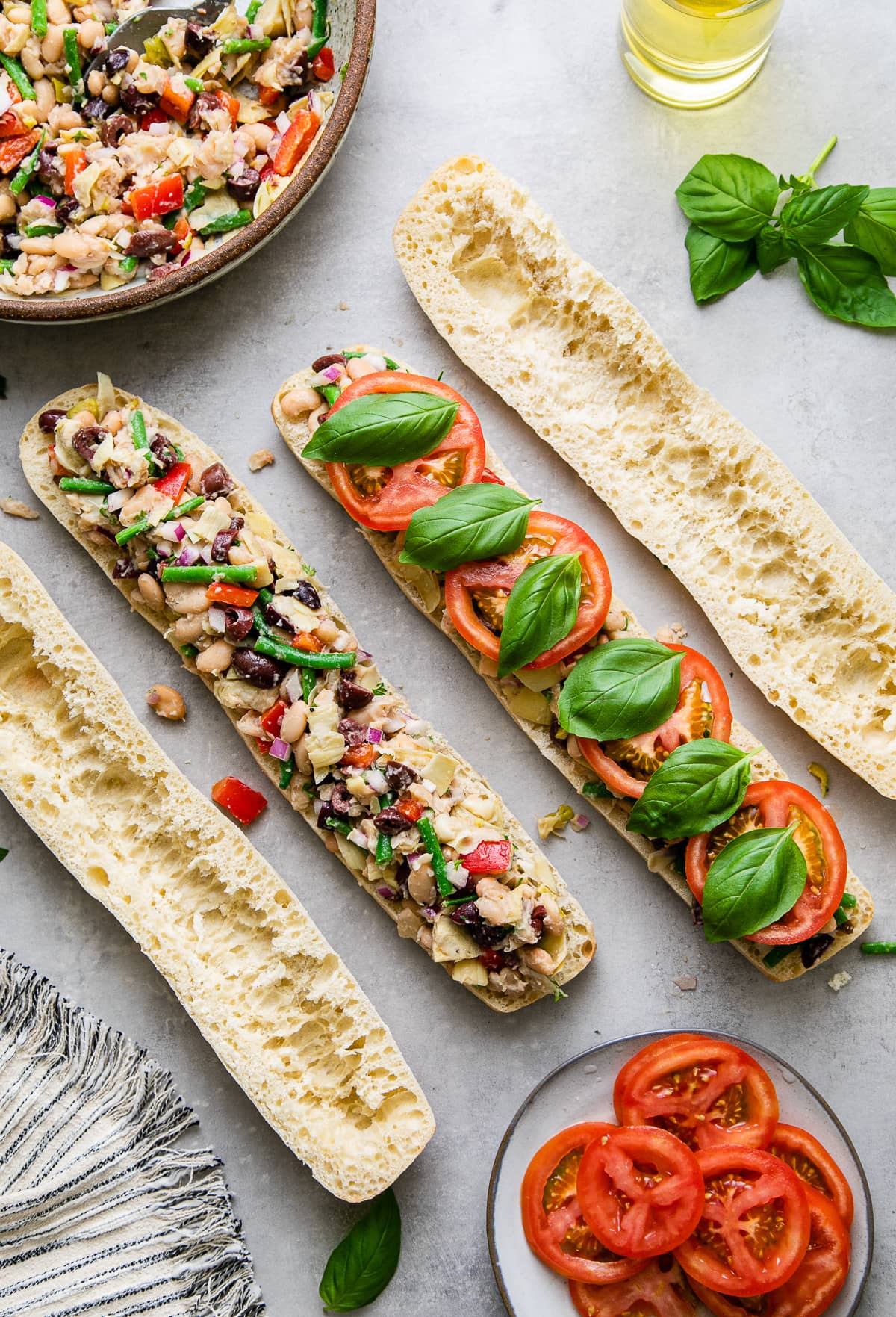 top down view showing the process of layer vegetarian pan pagnat with bean nicoise.