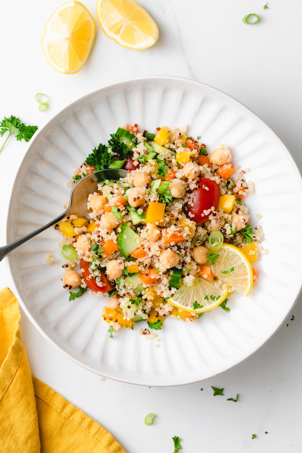 top down view of serving of quinoa and chickpea salad with spoon.