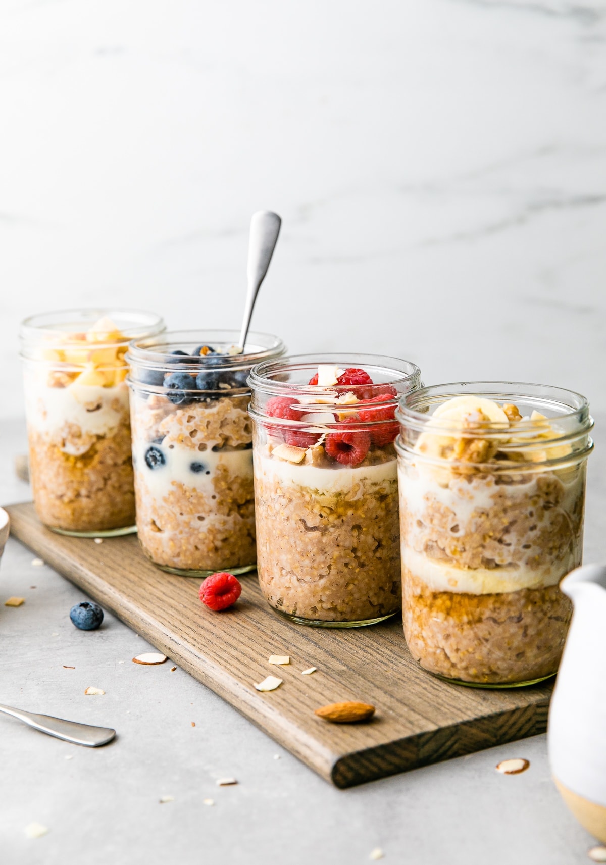 head on view of 4 steel cut breakfast jars with flavorful toppings.