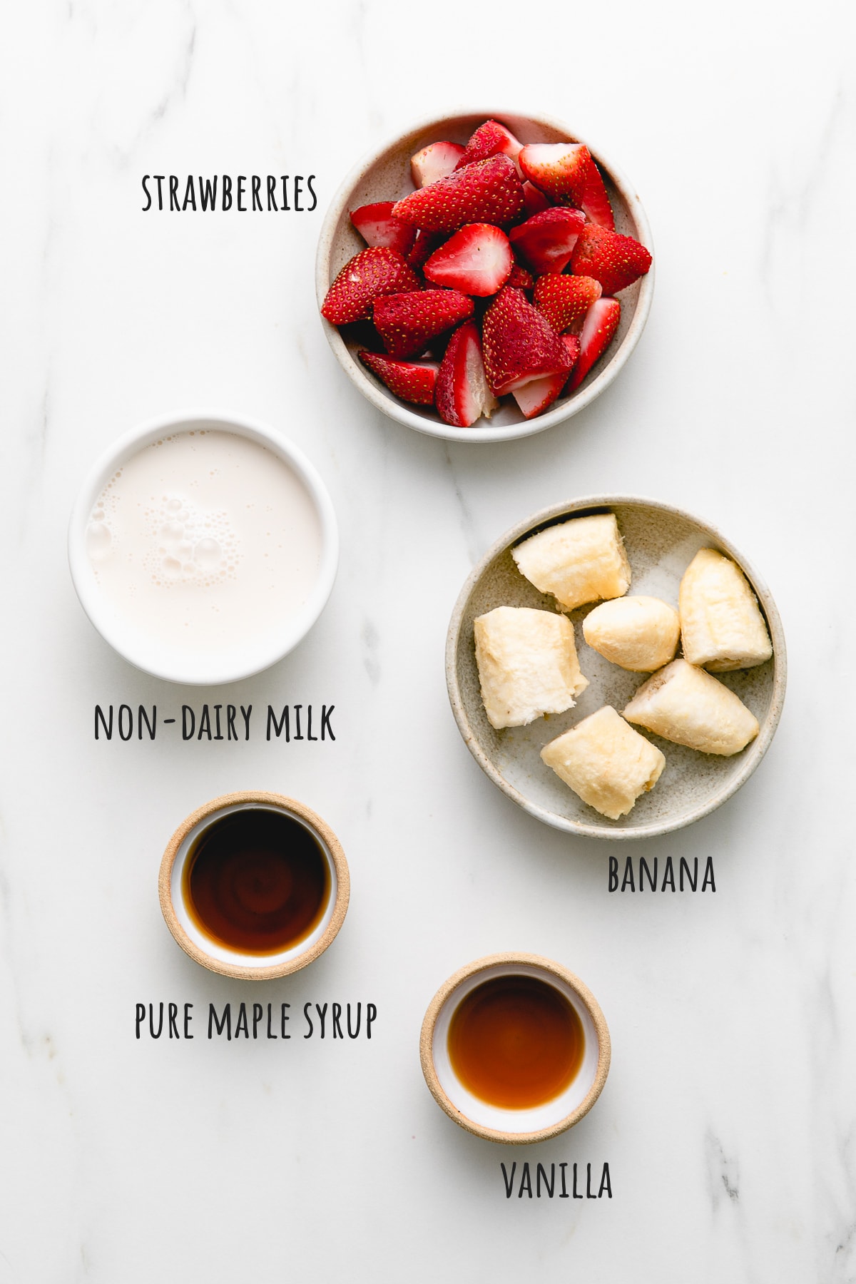 top down view of ingredients used to make vegan strawberry milkshake.