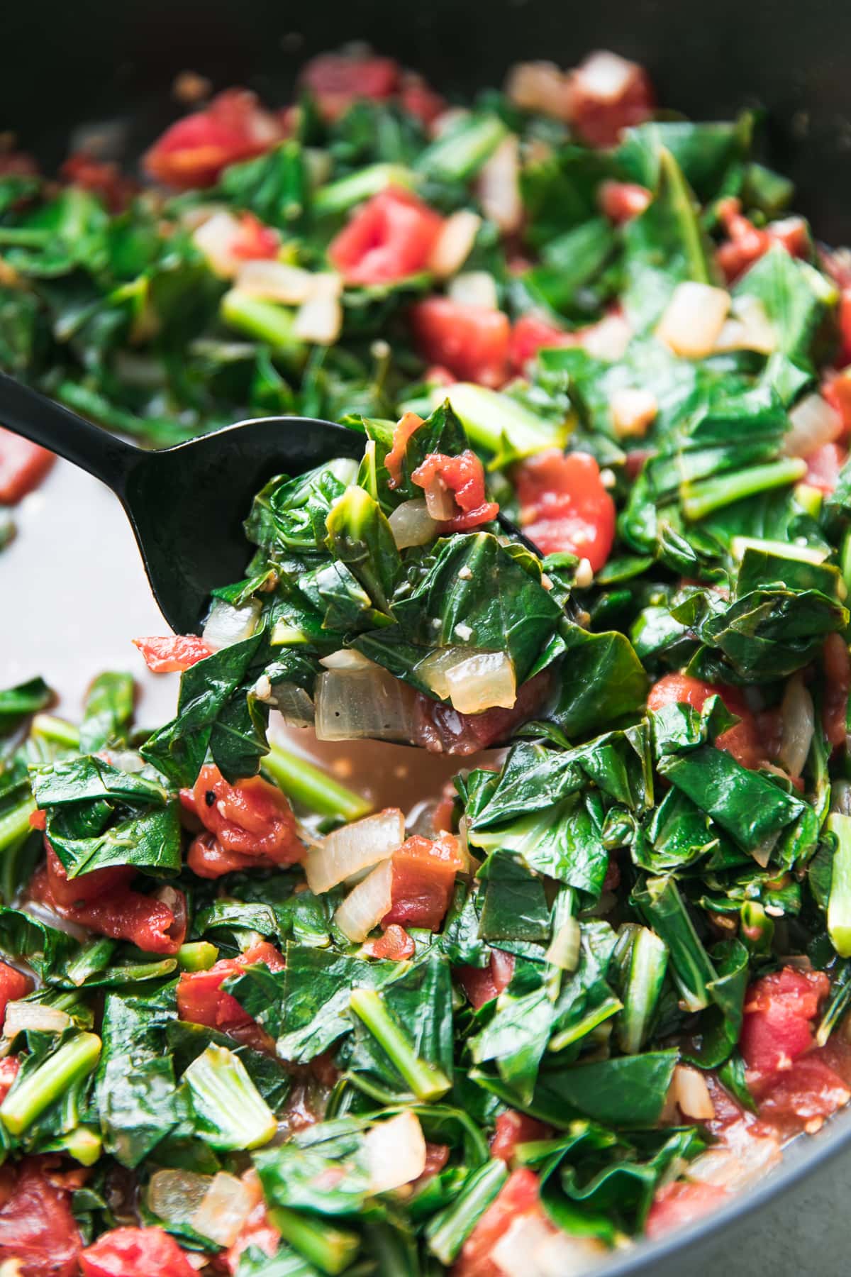 side angle view of vegan collard greens in a pot.