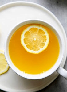 top down view of lemon ginger detox tea in a cup.