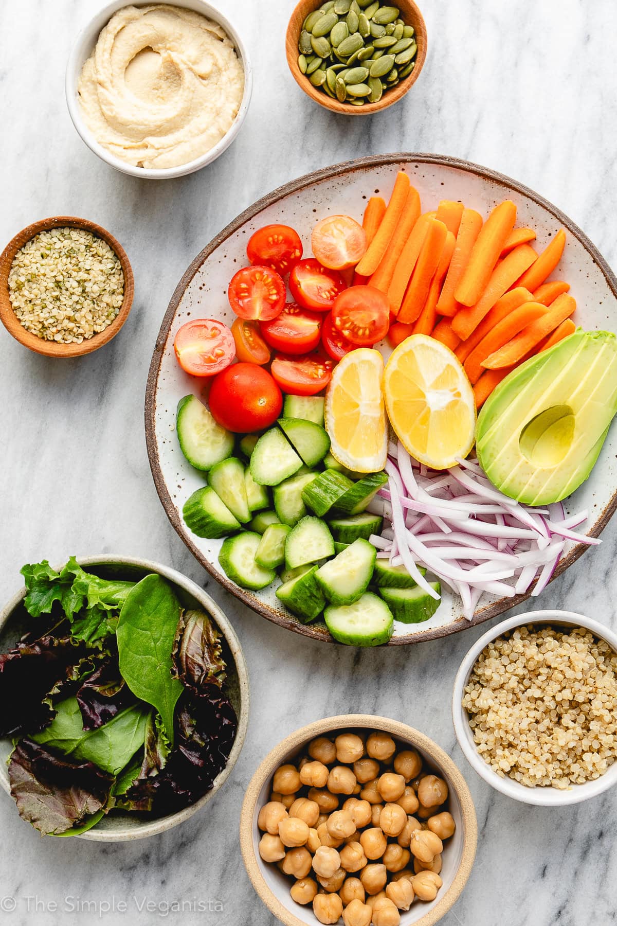 top down view of ingredients used for easy hummus bowl recipe on a marble slab.