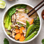 top down view healthy miso noodle bowl with chopsticks and items surrounding.