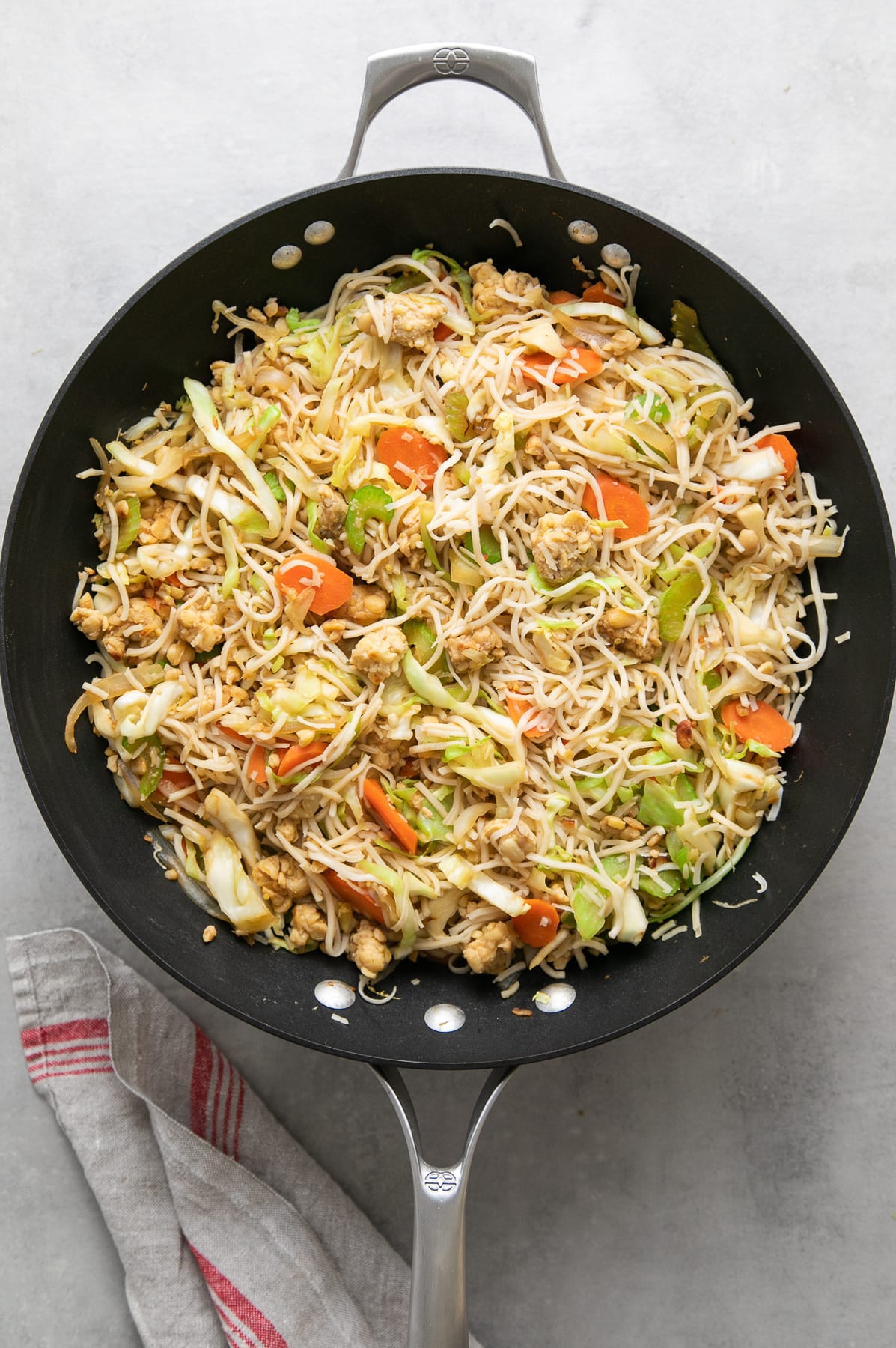 top down view of freshly made batch of tempeh chow mein in wok.