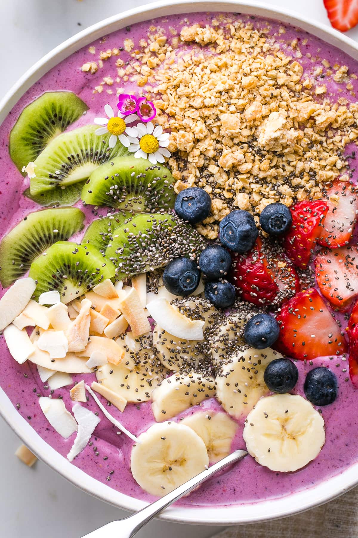 top down view of healthy smoothie bowl with variety of toppings.