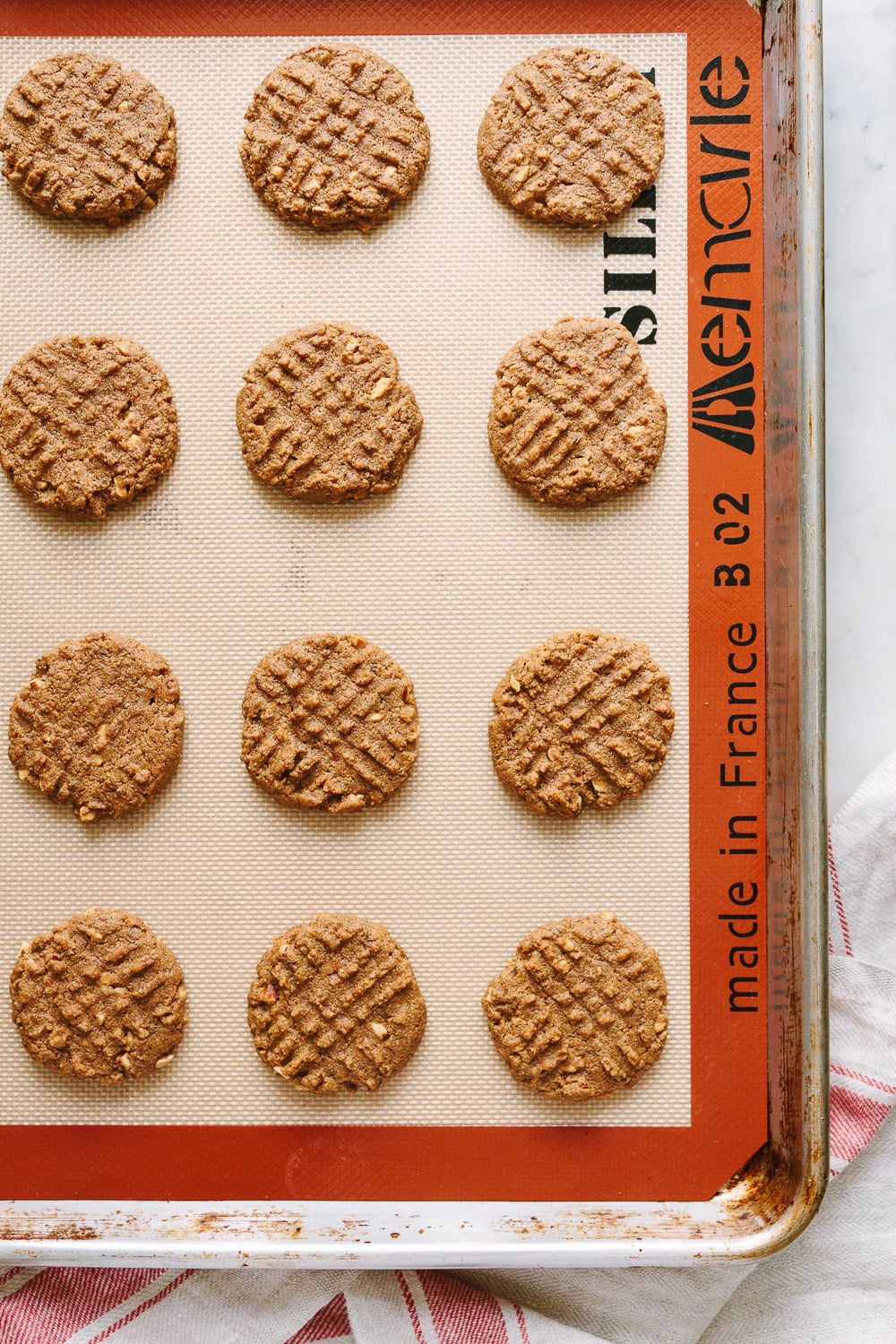 top down view of freshly baked 4 ingredient almond butter cookies on a baking sheet.