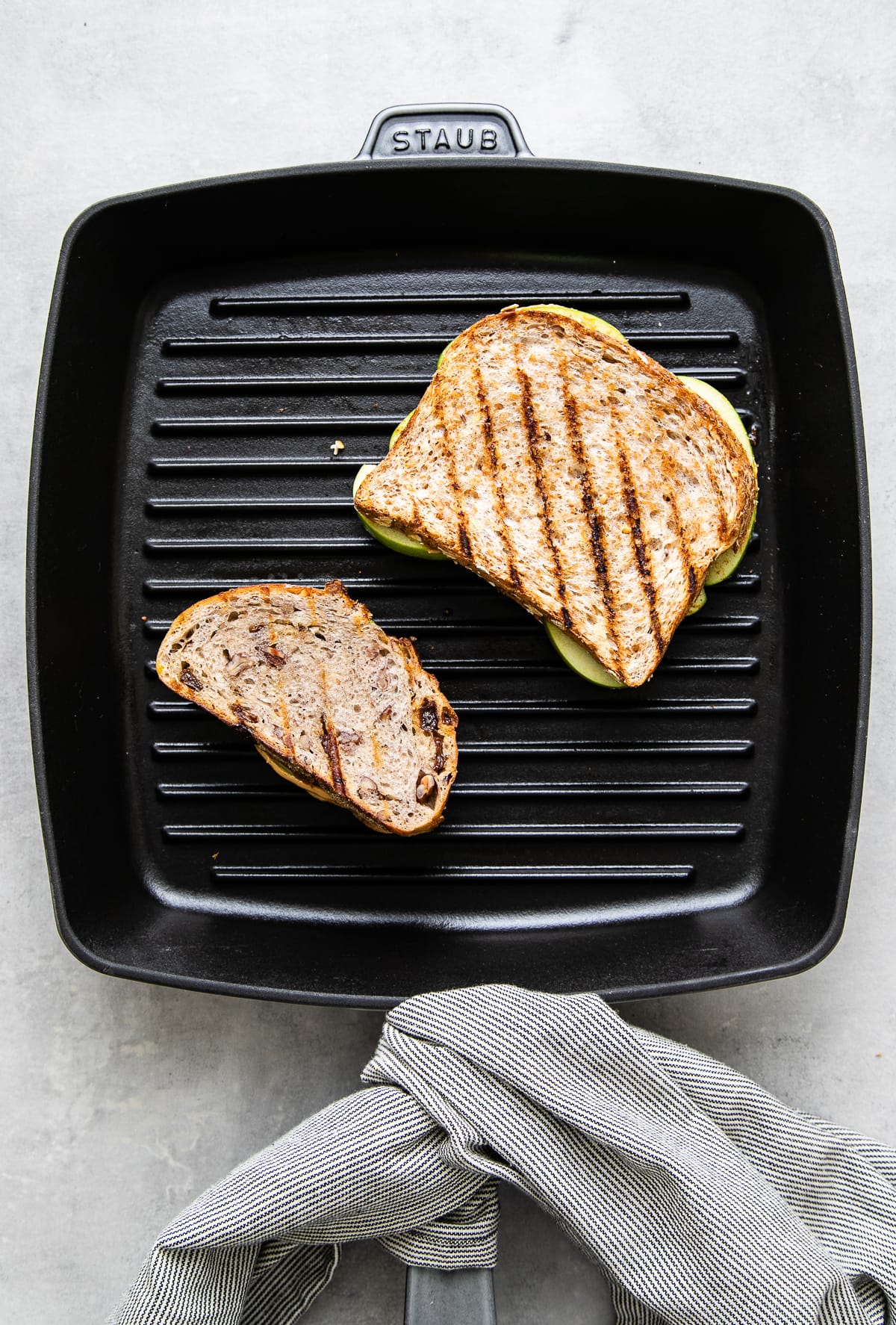 top down view of two sandwiches on a griddle.