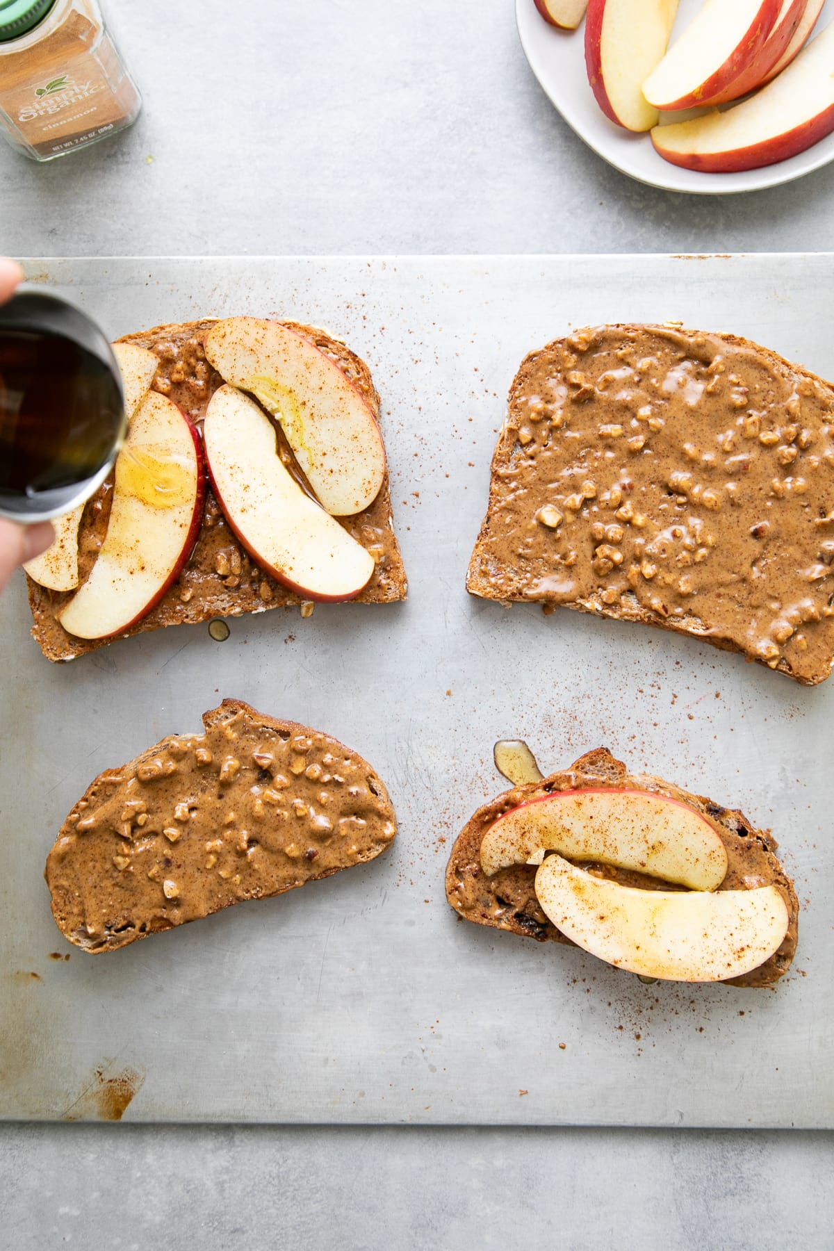 top down view showing the process of assembling healthy peanut butter apple sandwiches.