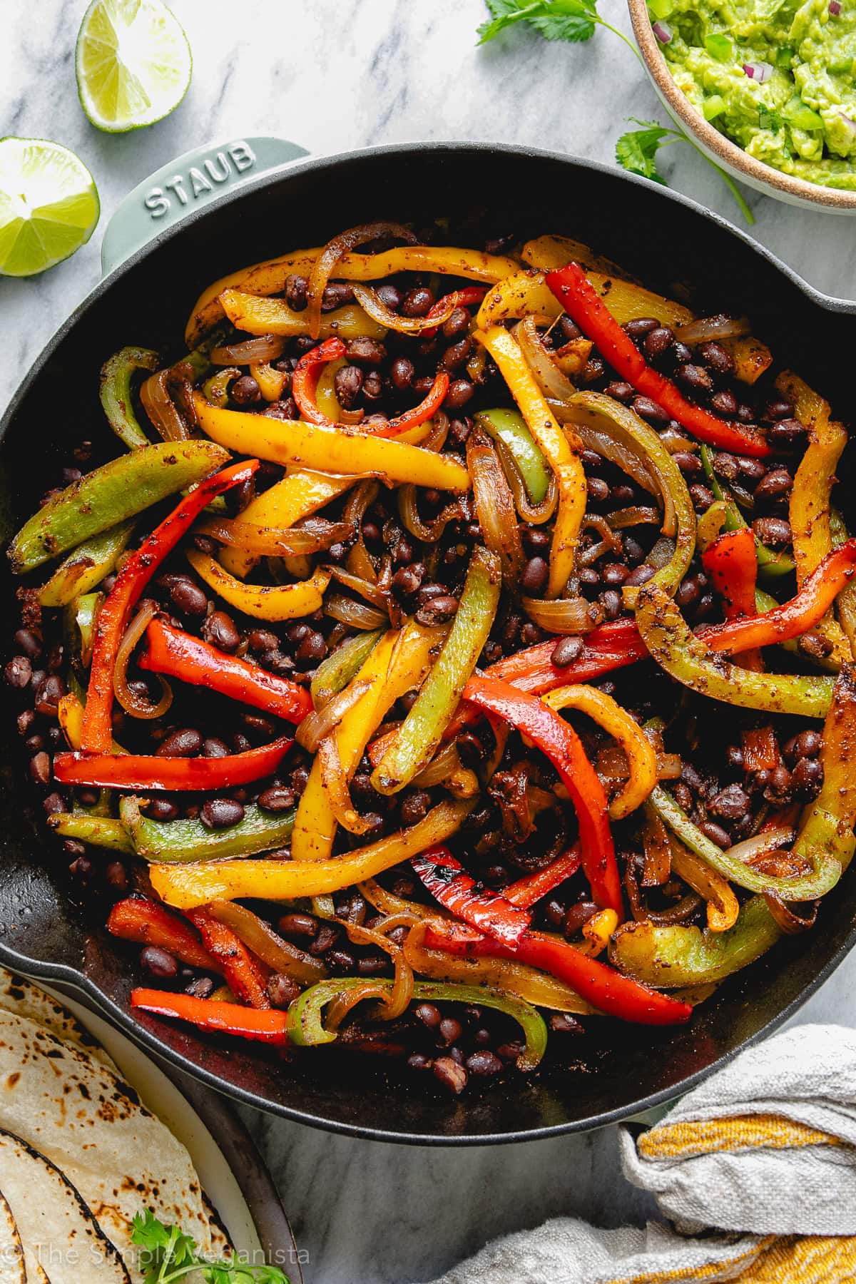 Close-up of black bean fajita filling with colorful bell peppers and onions.
