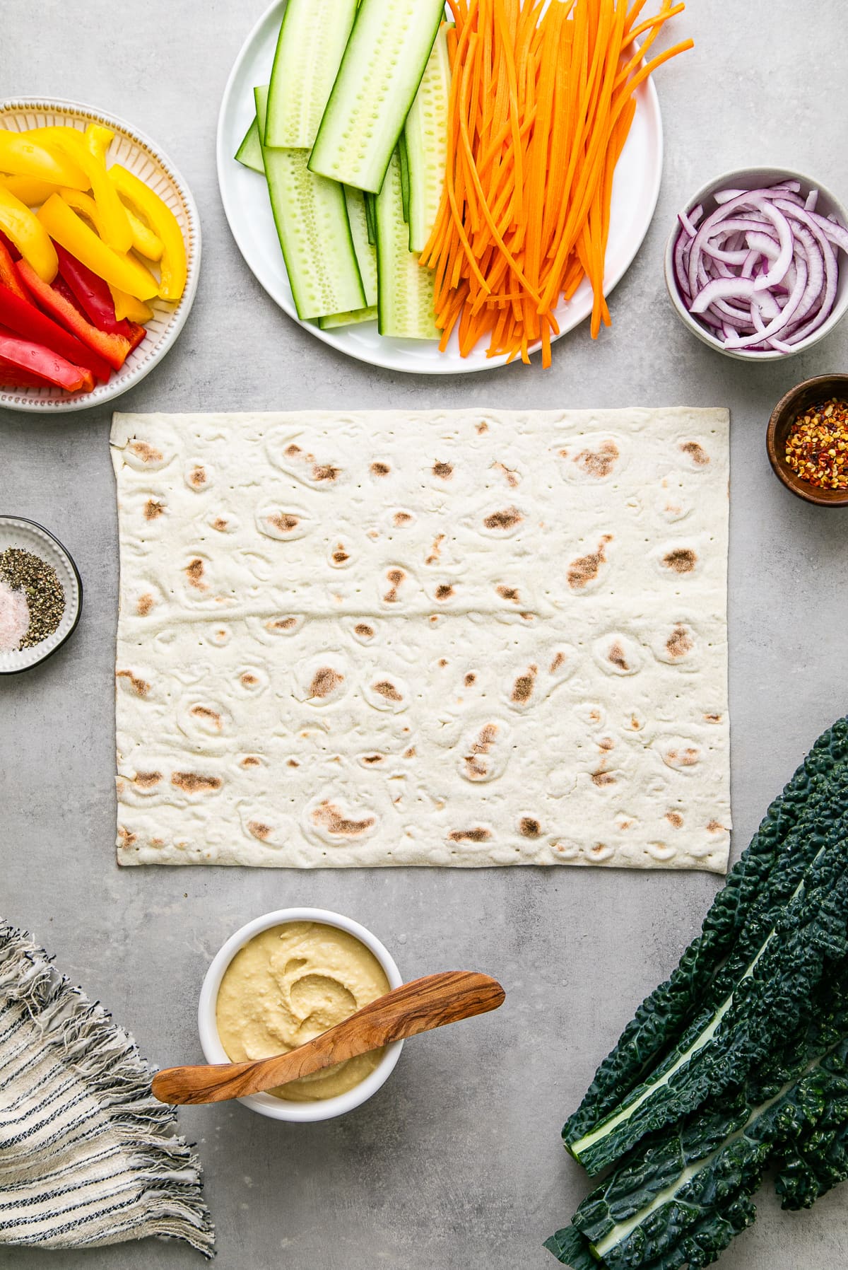 top down view of ingredients needed to make the best hummus veggie wrap.