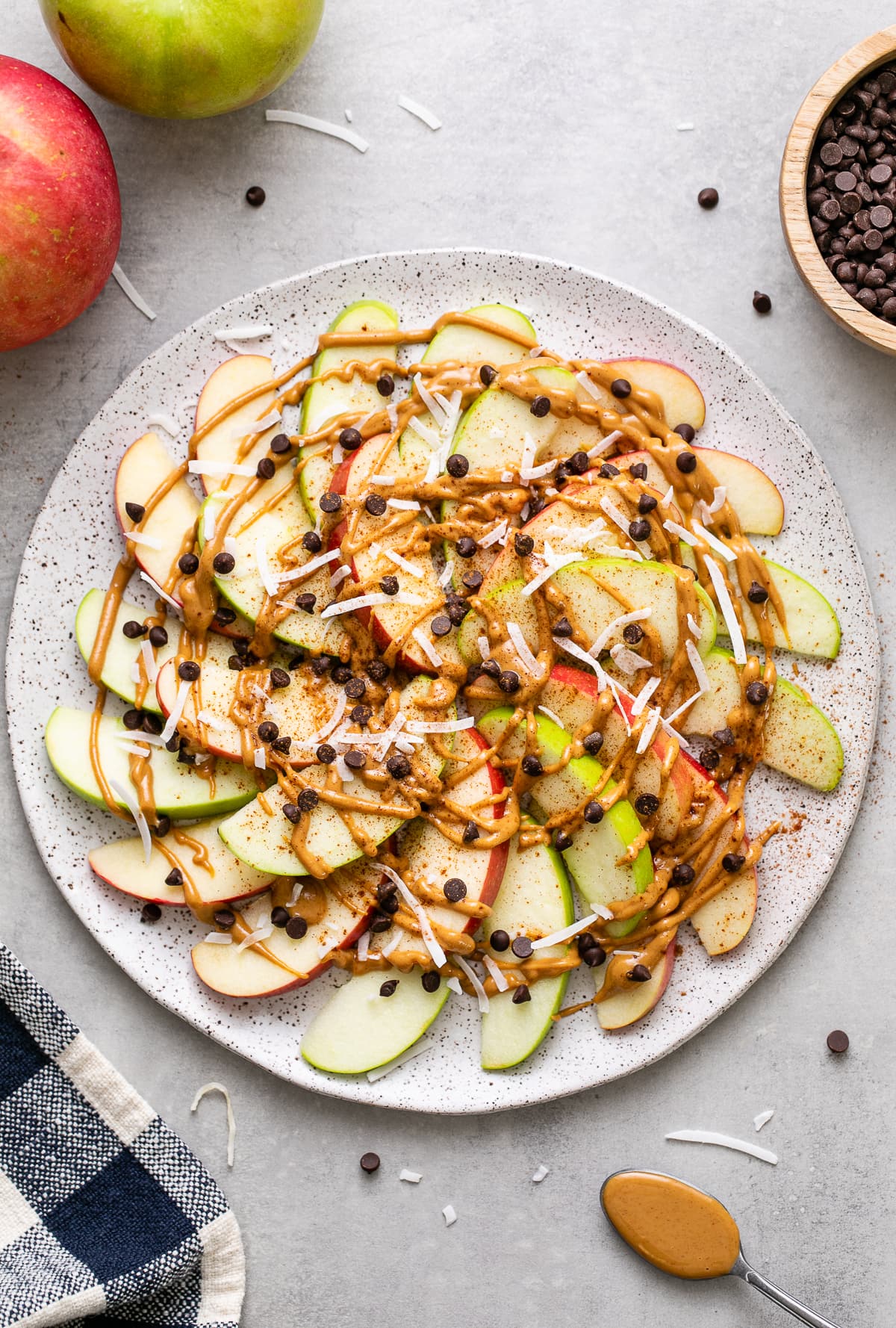 top down view of plate with healthy apple nachos and items surrounding.