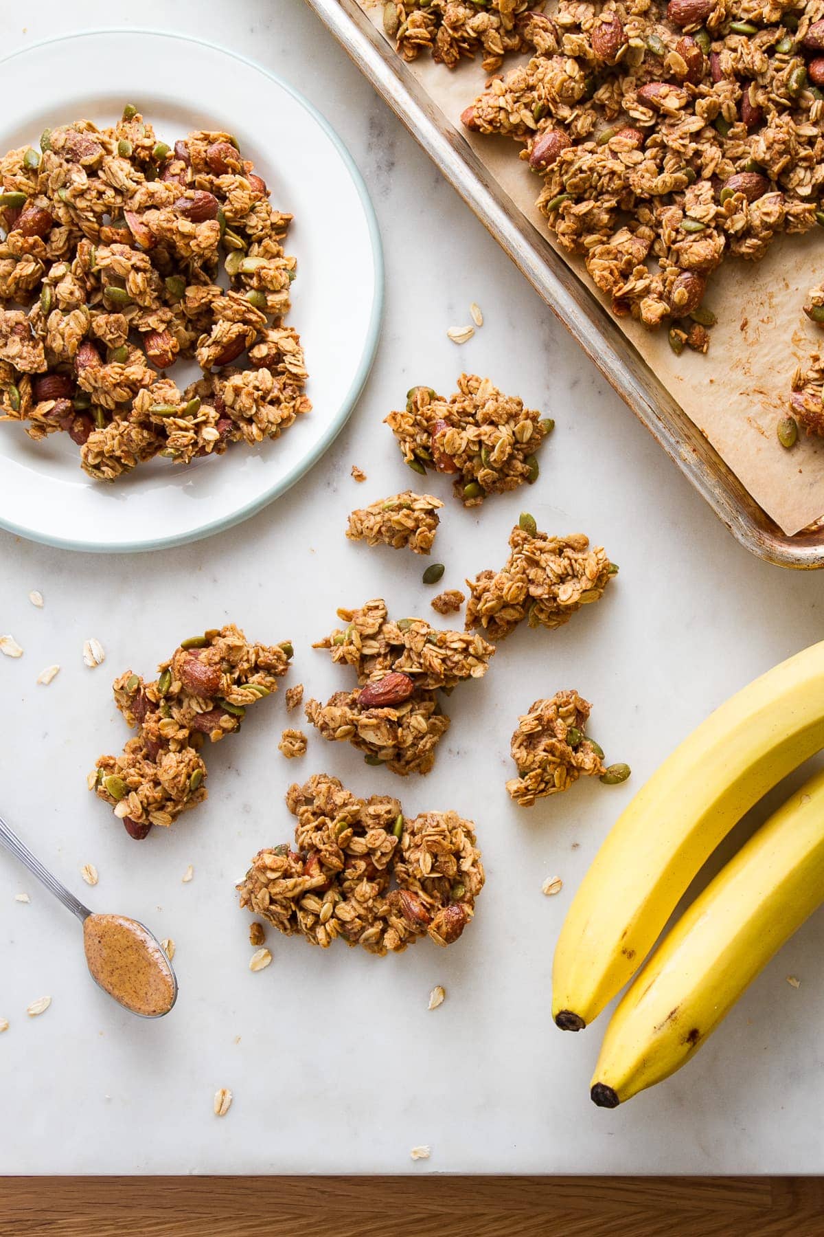 top down view of freshly made peanut butter banana granola cooled and broken into clusters.