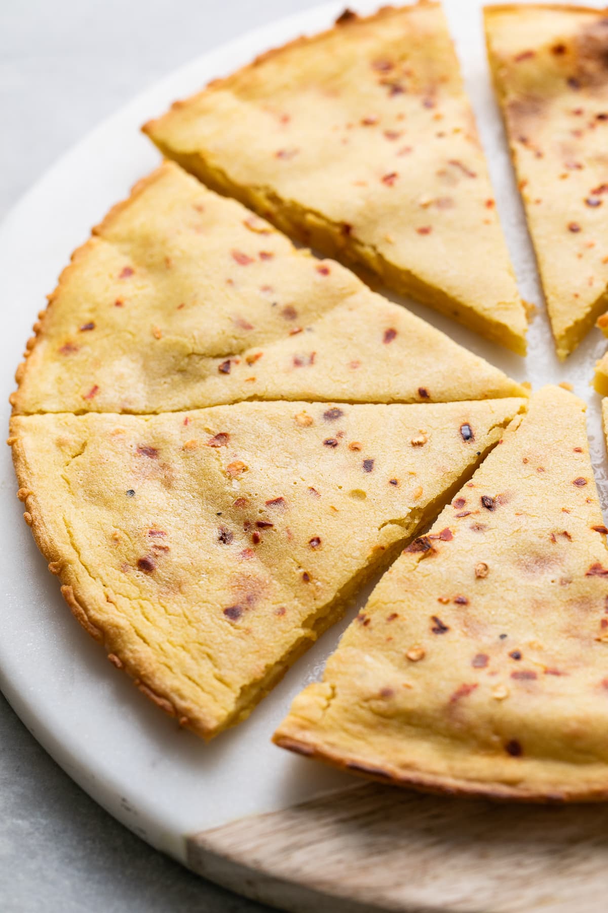 side angle view of sliced socca flatbread.