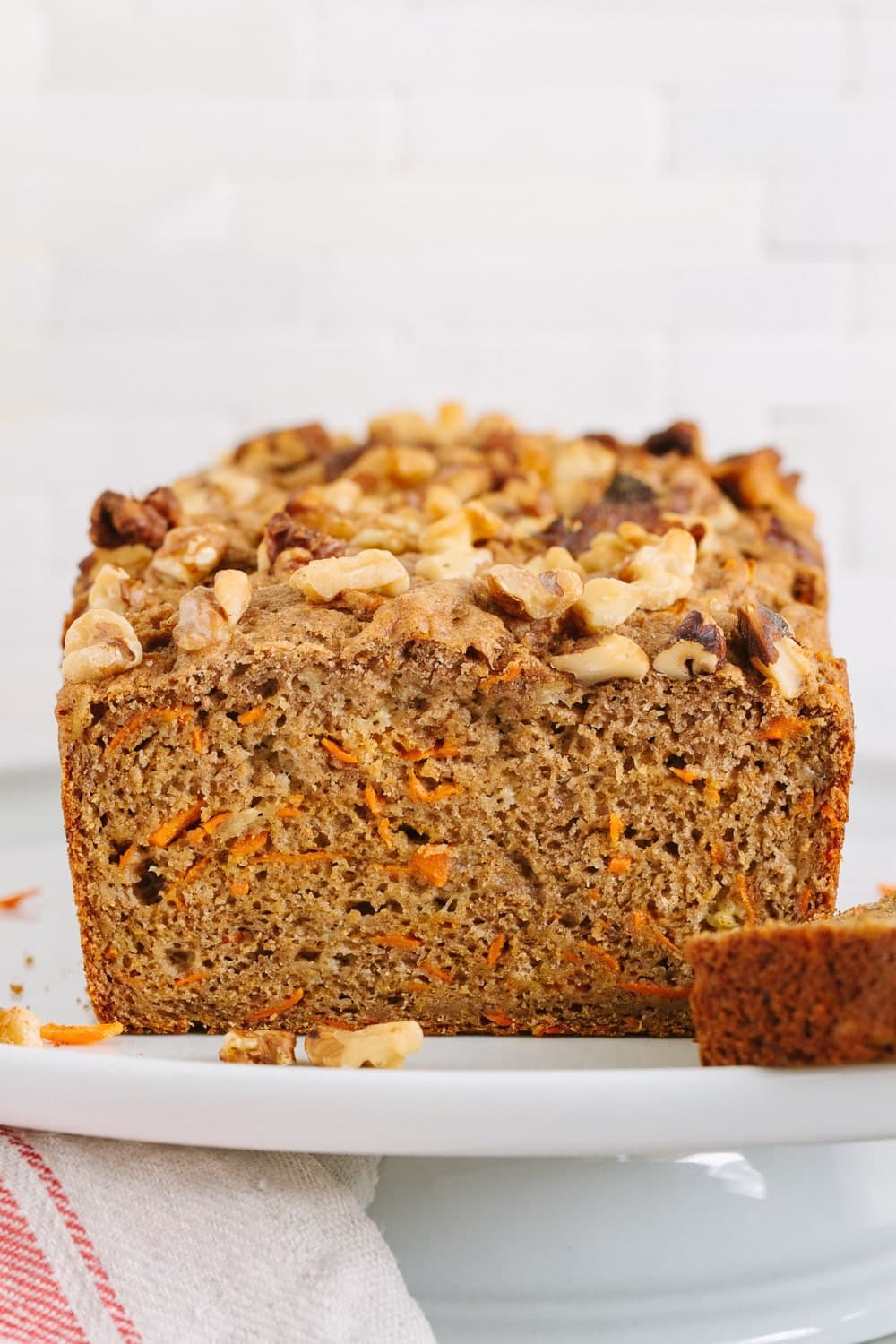 head on view of vegan carrot banana bread on a cake stand.