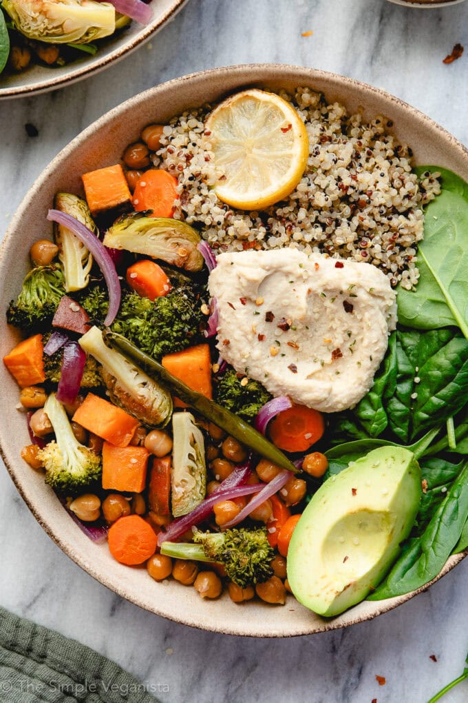 up close view of a healthy nourish bowl with roasted veggies and avocado.