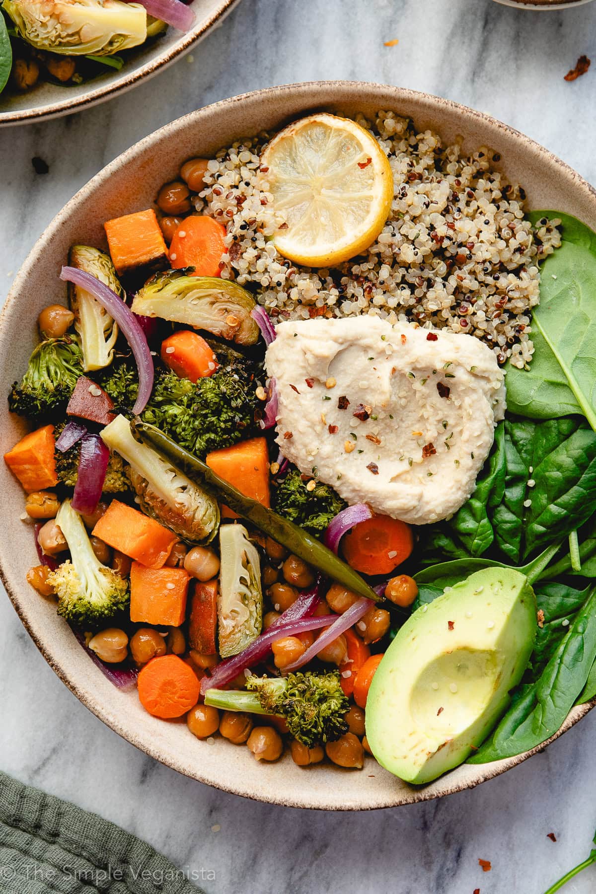 up close view of a healthy nourish bowl with roasted veggies and avocado.