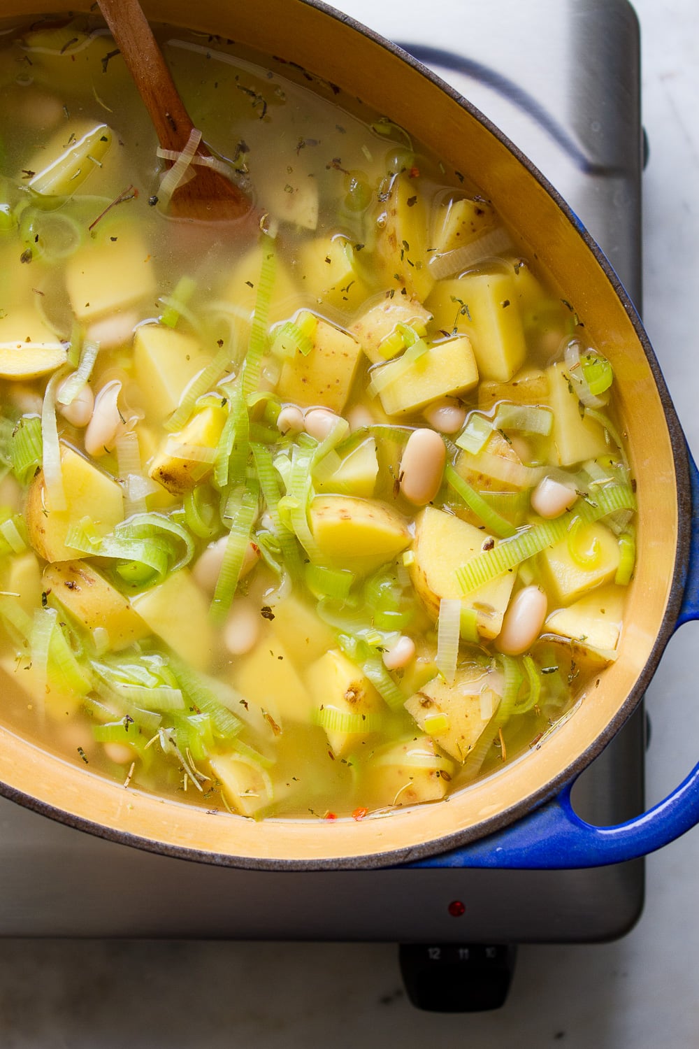 top down view of potato, leek and white bean soup before simmering.