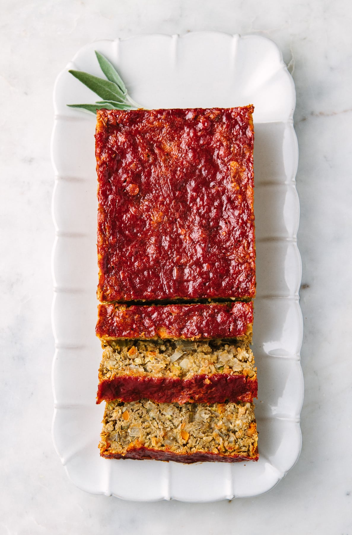 top down view of freshly baked lentil loaf on a rectangular serving plate.