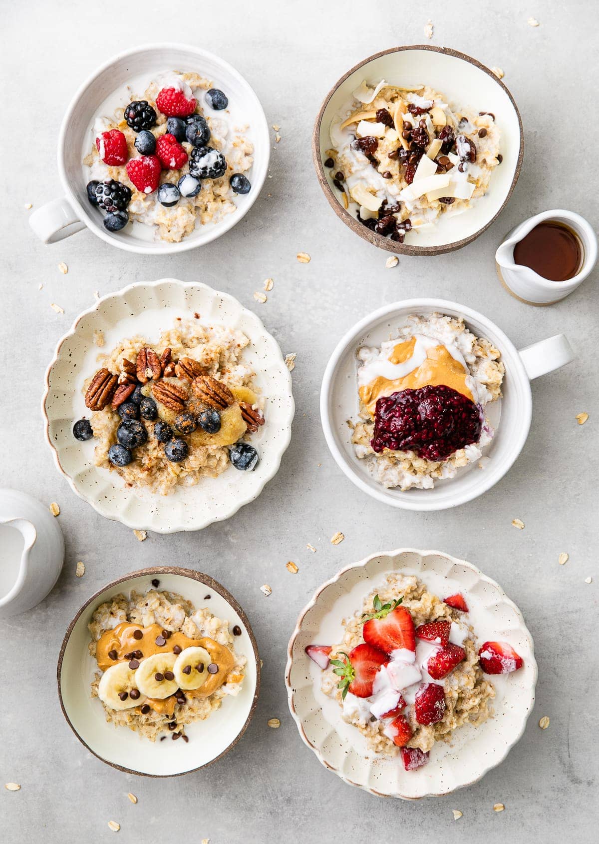 top down view of 6 bowls of healthy oatmeal with various toppings.